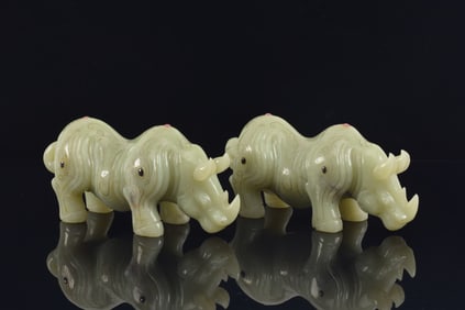 2 hardstone rhinoceroses inlaid with gemstones and gold. China. 20th century. 6.5in length.