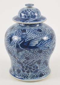 Porcelain covered jar. China. 18th/19th century. Underglaze blue phoenix and peony pattern. Chip to