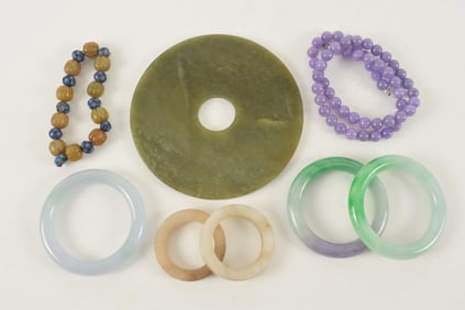 Lot of 8 jades. To include: a pi disc, 3 bracelets, 2 rings, a bead bracelet and a necklace.