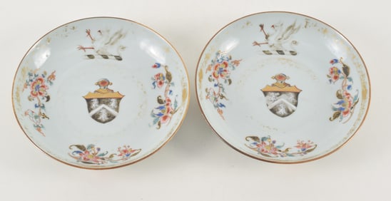 Pair of porcelain saucers. China. 18th century. Armorial crests, emblems and floral sprigs. 6.25in.