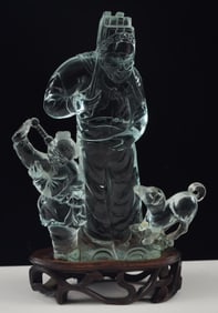 Carved aqua colored glass group. China. 20th century.