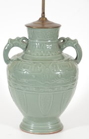 Porcelain vase. Japan. 19th century. Dark celadon glaze. Molded decoration of archaic scrolling and