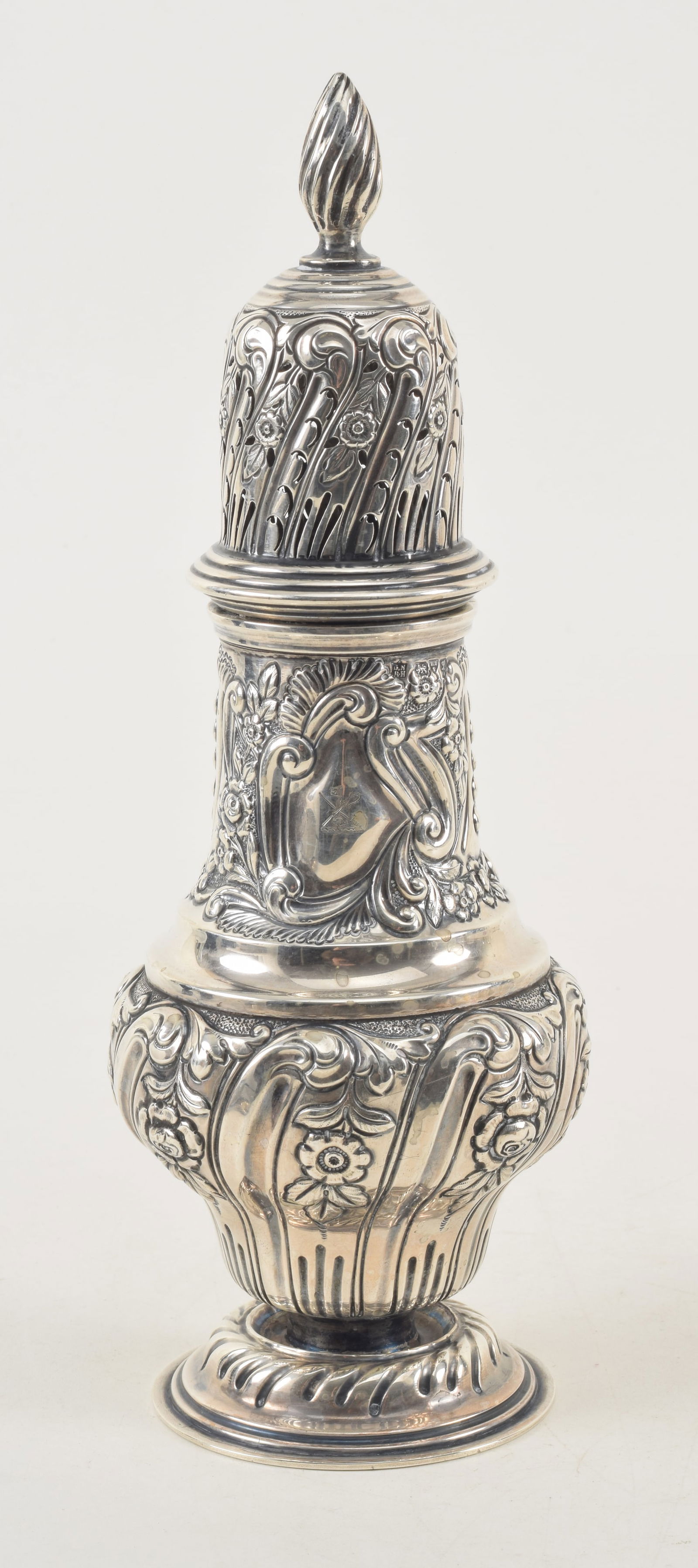 English sterling silver tall muffineer. Repousse floral decorated body. Armorial crest with (1 of 16)