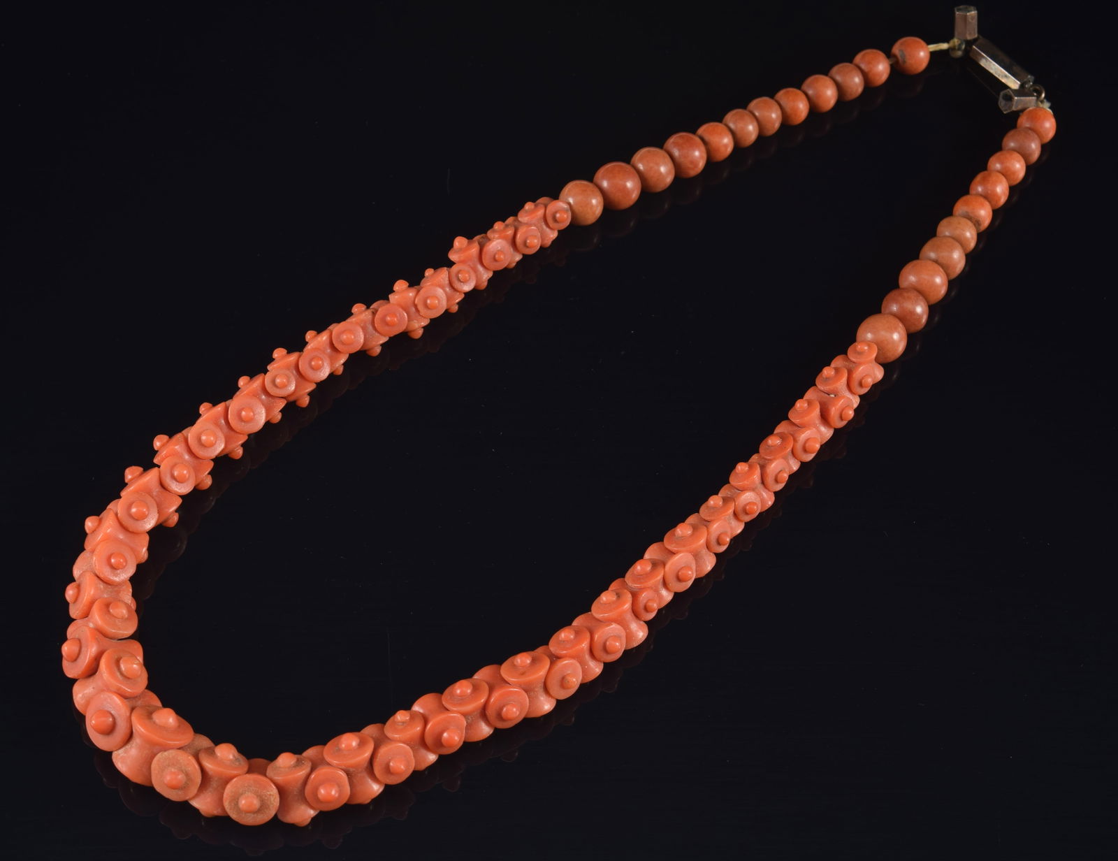 18th/19th century carved coral necklace carved in unusual graduated chain link pattern with: 18th/19th century carved coral necklace carved in unusual graduated chain link pattern with graduated beads. Gold or silver clasp. 9.75in long closed.