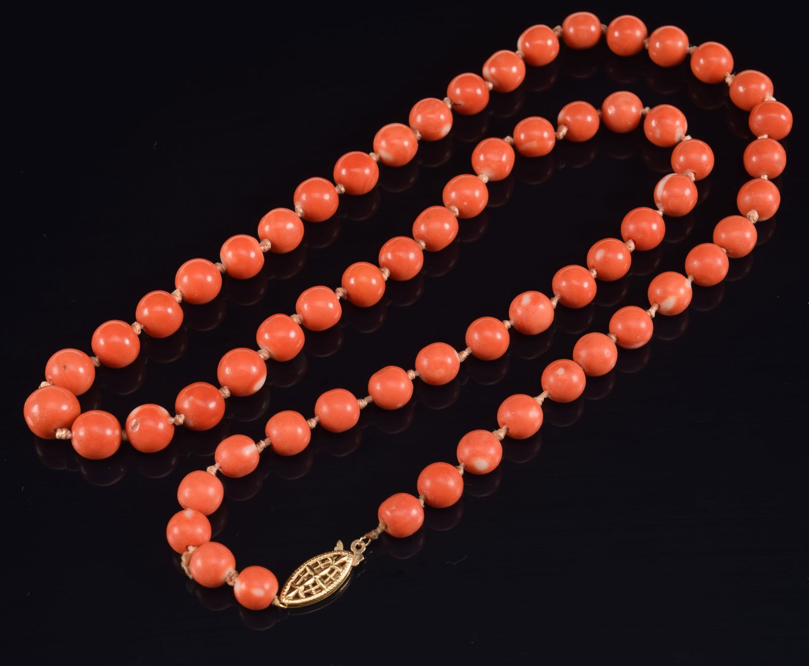 14K gold coral beaded necklace. Beads approx. 8.3mm diameter. Clasp marked 14K. 24in length. 53.9 (1 of 3)