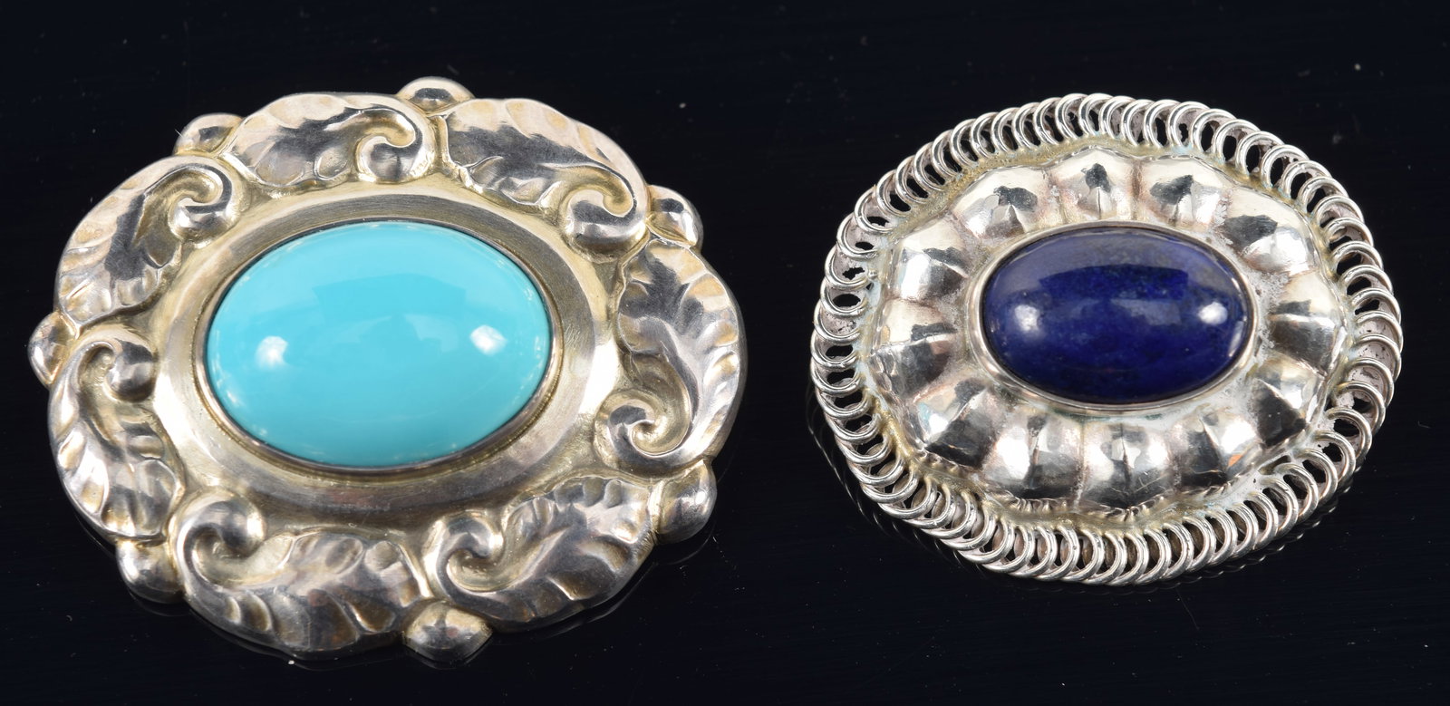 Georg Jensen, Denmark. 2 Sterling silver brooches. Oval floral wreath with turquoise, #60 and other: Georg Jensen, Denmark. 2 Sterling silver brooches. Oval floral wreath with turquoise, #60 and other oval with lapis, # 155. 0.8 ozt. Widths 1 1/2 in. and 1 1/4 in.