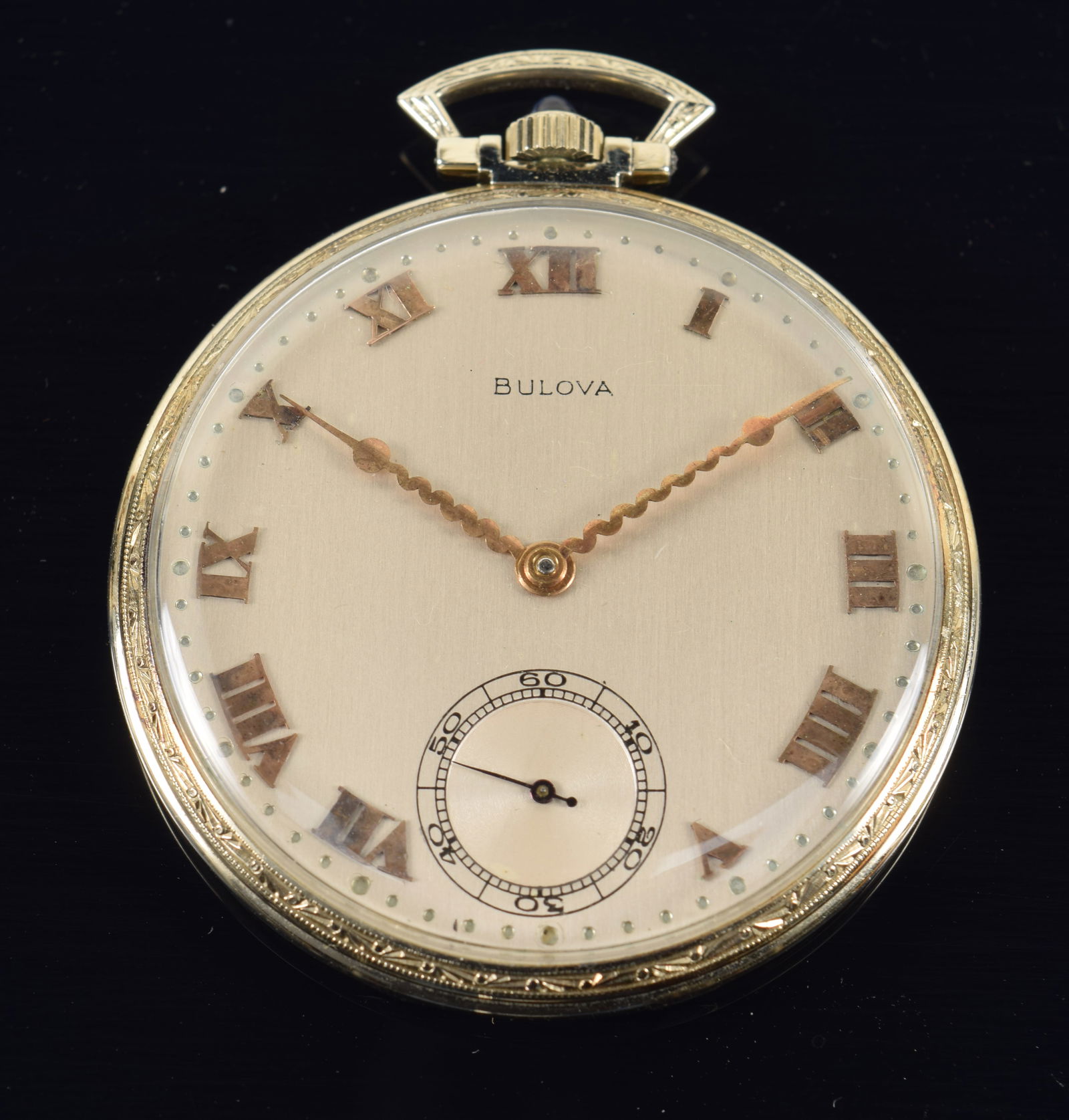 19K white gold Bulova "Phantom" open face pocket watch. Gold hands and numerals. Sugarloaf sapphire: 19K white gold Bulova "Phantom" open face pocket watch. Gold hands and numerals. Sugarloaf sapphire mounted winder. 18 jewel movement. Case marked. Serial number 1148117. 1.75in diameter. 38.6 grams.
