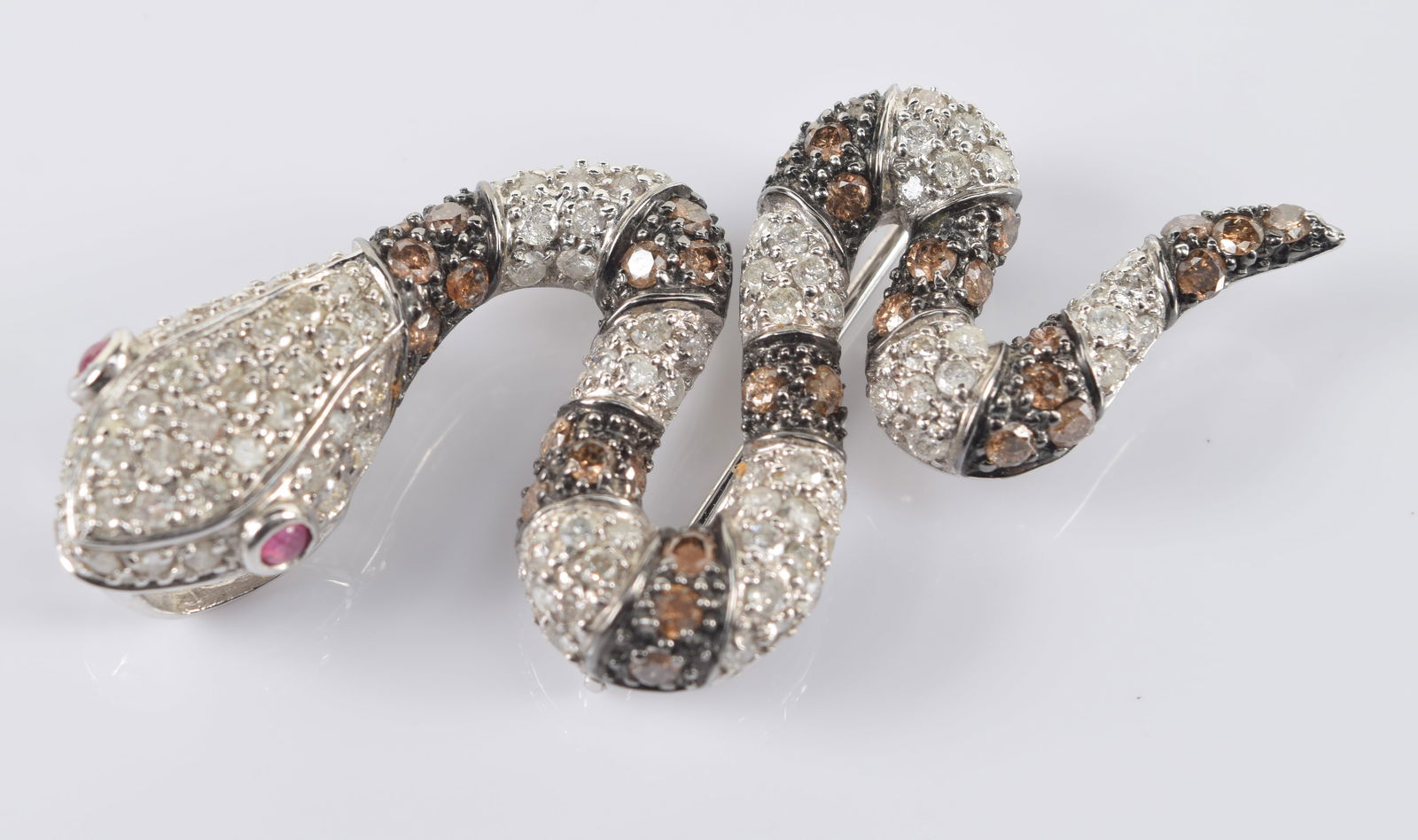 14K white gold diamond encrusted snake form pin. Bands of colorless and brown diamonds. Ruby set (1 of 4)