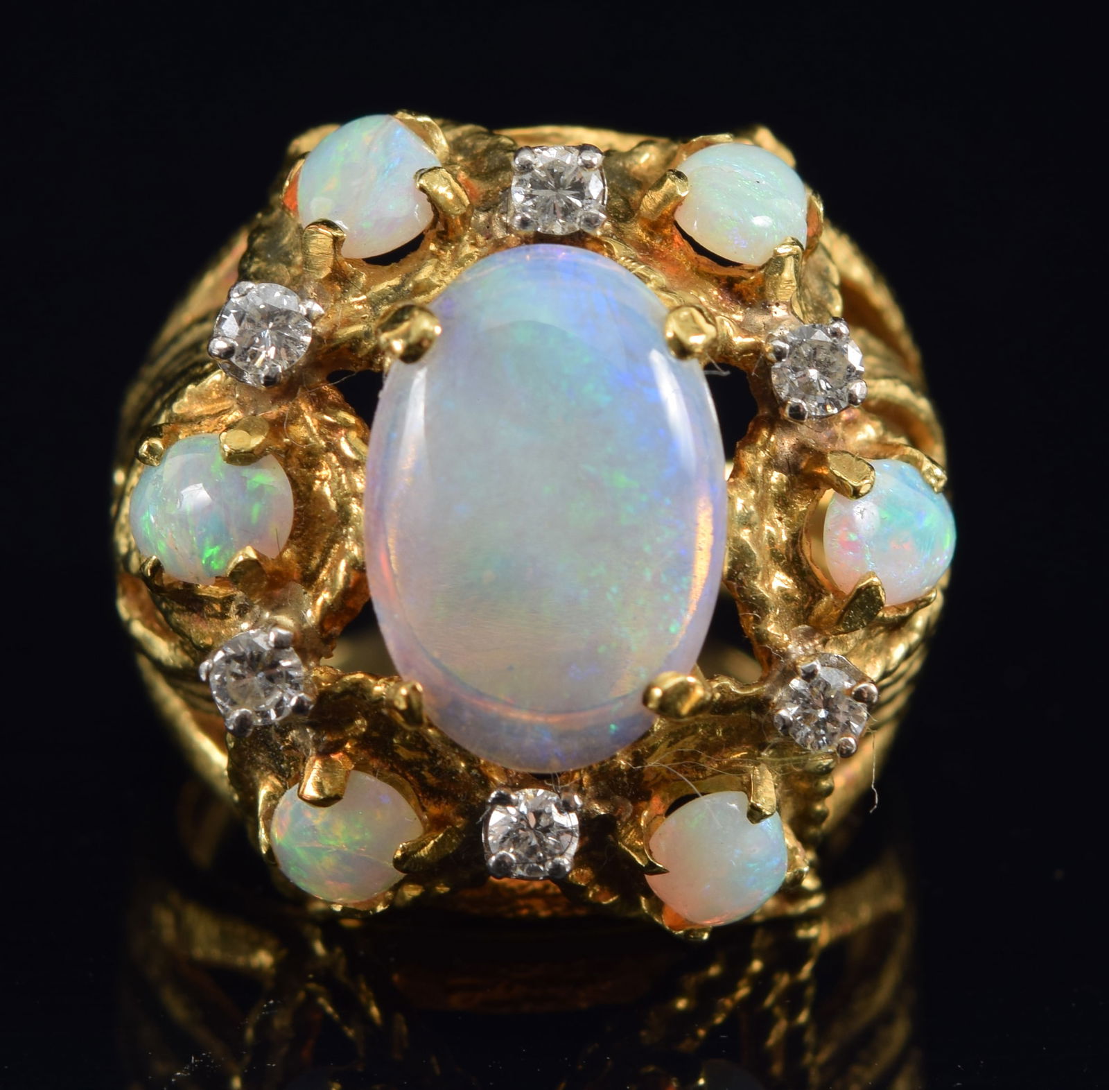 18K gold opal and diamond mounted ring. Openwork foliate design setting. Central oval opal measures (1 of 8)