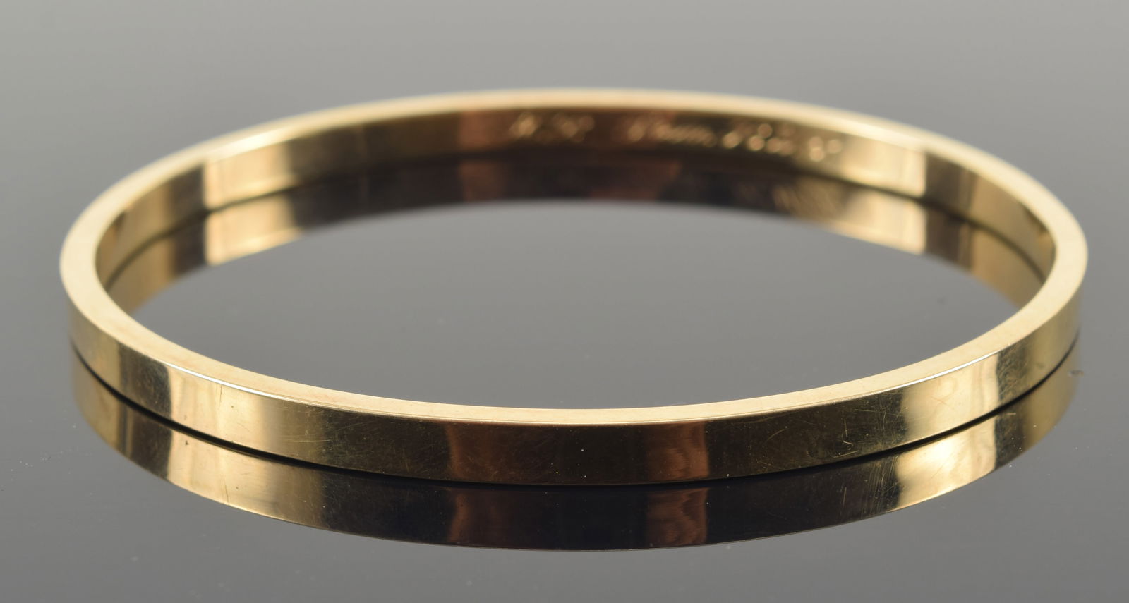 14K gold bangle bracelet. Stamped 14K. Gift inscription with initials. 2.5in wide opening. 9 grams. (1 of 4)