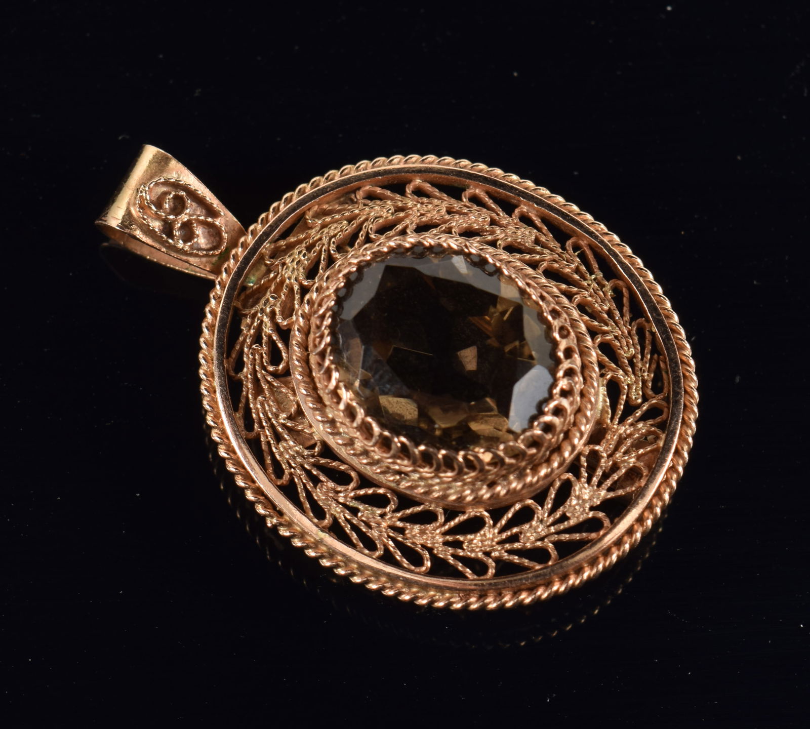 14K gold smoky quartz pin/pendant. Filigree wirework setting. Marked 14ct and maker's mark. 1 1/3in.: 14K gold smoky quartz pin/pendant. Filigree wirework setting. Marked 14ct and maker's mark. 1 1/3in. 5.7 grams.