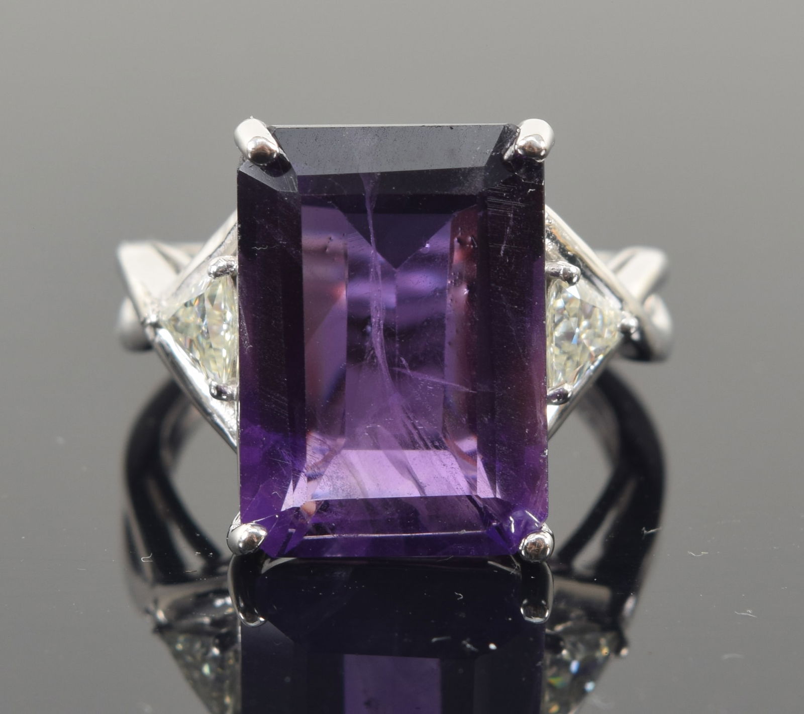 10K white gold amethyst and diamond cocktail ring. Rectangular cut amethyst measures 14 x 10mm.: 10K white gold amethyst and diamond cocktail ring. Rectangular cut amethyst measures 14 x 10mm. Marked GSK 10KT. Ring size 5. 4.5 grams.