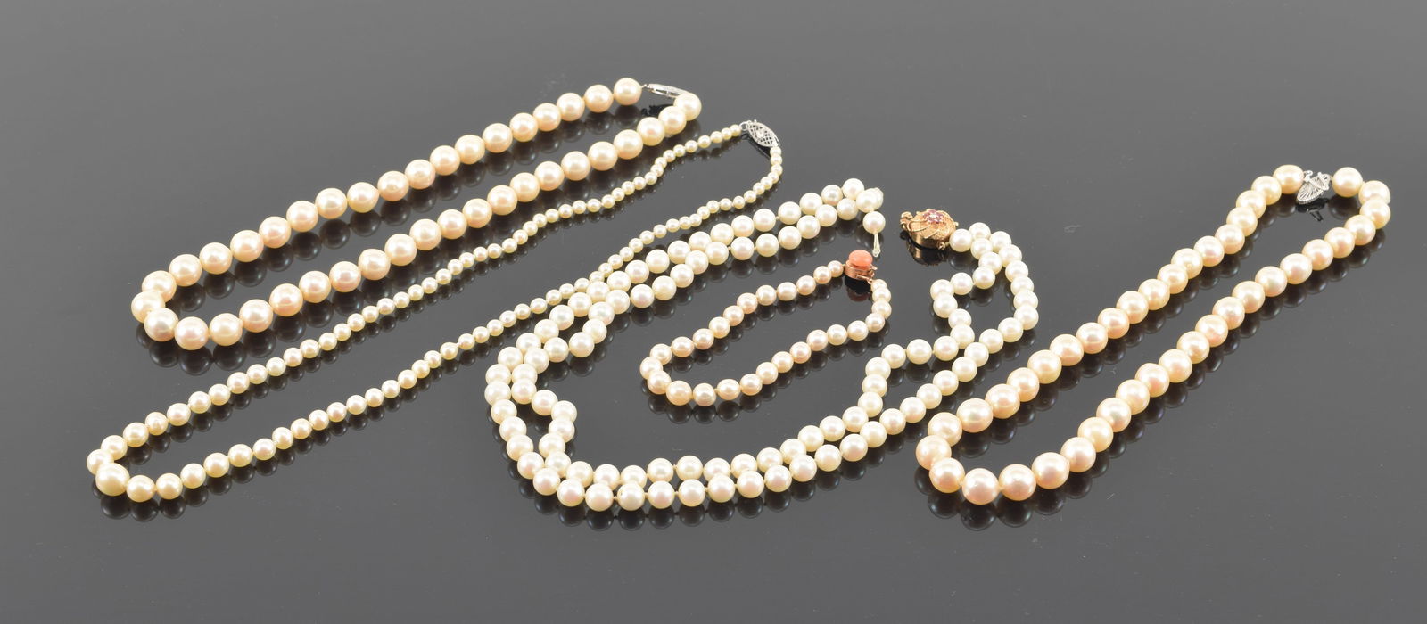 5 gold clasp pearl necklaces and bracelets. 4 marked 14K, one with coral bead unmarked but tests as (1 of 6)