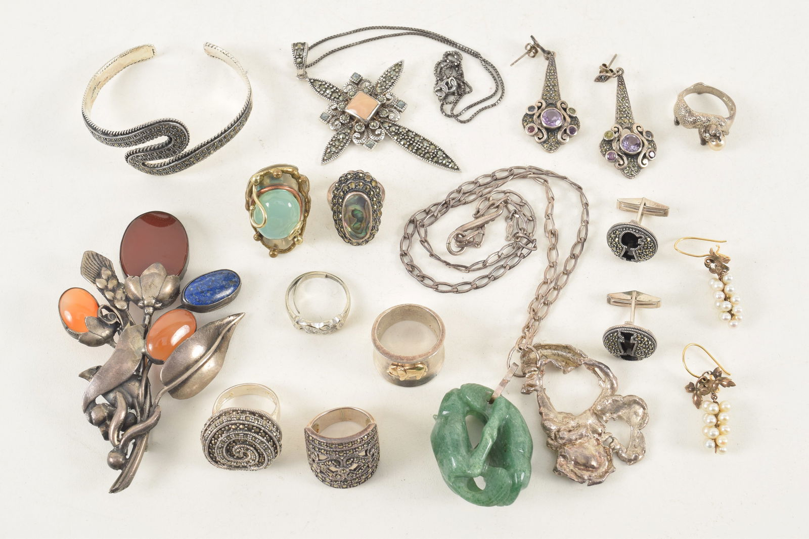 Assortment of silver and gold jewelry. To include: gold grape cluster earrings, large silver floral: Assortment of silver and gold jewelry. To include: gold grape cluster earrings, large silver floral pin set with lapis and agate, cat form ring with pearl, necklaces, earrings, etc. Weight of silver i