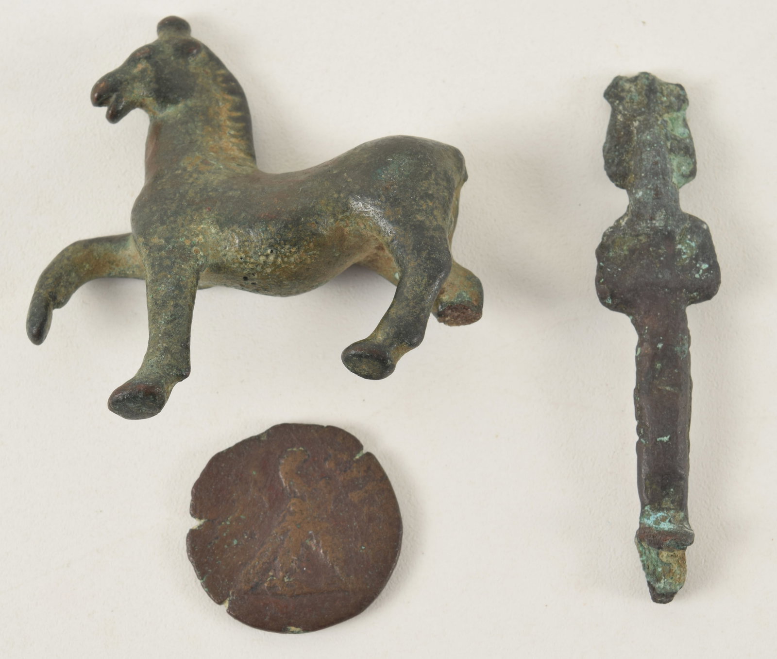 Lot of 3 bronze antiquities including a Roman coin, Egyptian figure, and a horse with broken leg. (1 of 7)