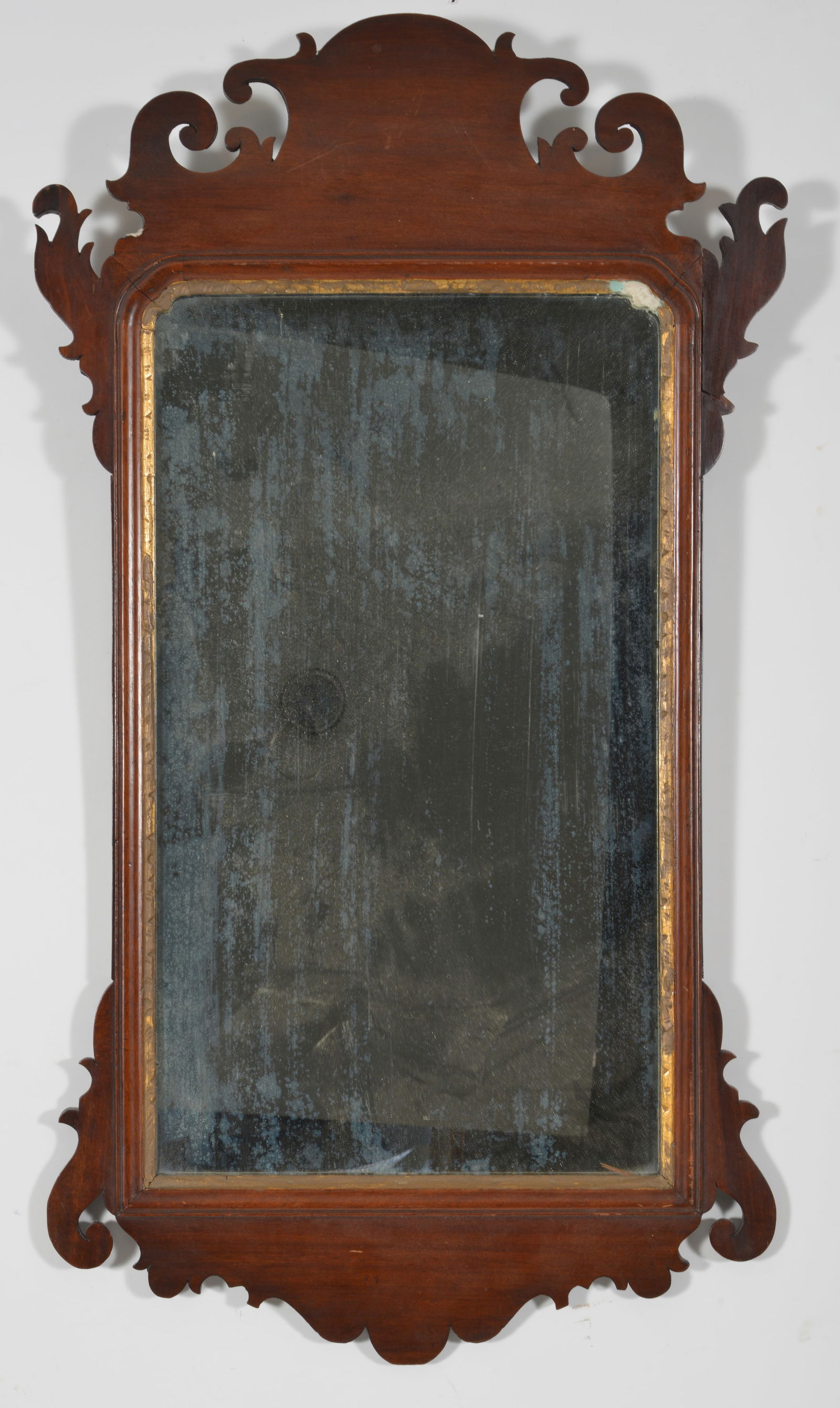 Labeled Chippendale mahogany looking glass with old London label of Matthew & George Kemp, 18th: Labeled Chippendale mahogany looking glass with old London label of Matthew & George Kemp, 18th Century. 35 x 20 in.