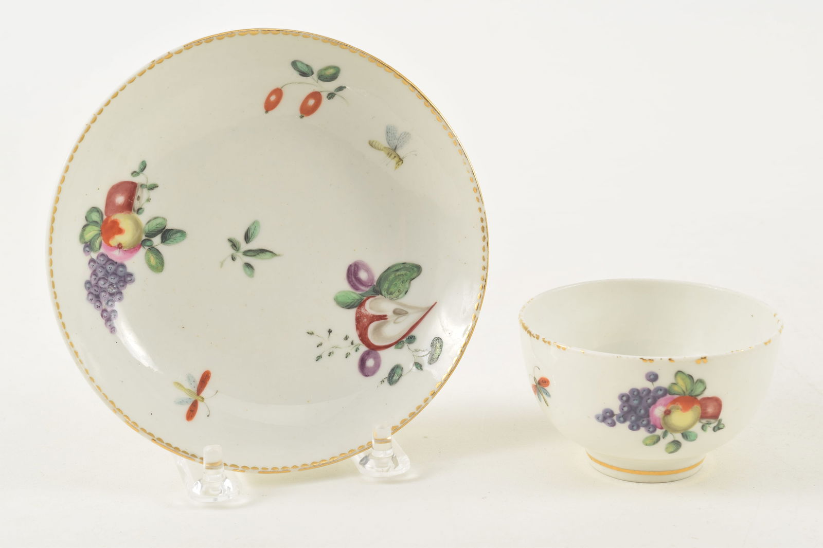 18th century English? porcelain cup and saucer with fruit and insect decoration. Gold anchor and D: 18th century English? porcelain cup and saucer with fruit and insect decoration. Gold anchor and D mark. Possibly Derby porcelain. Saucer 5in diameter. Cup 1 13/16in high. Provenance: From a Massachus