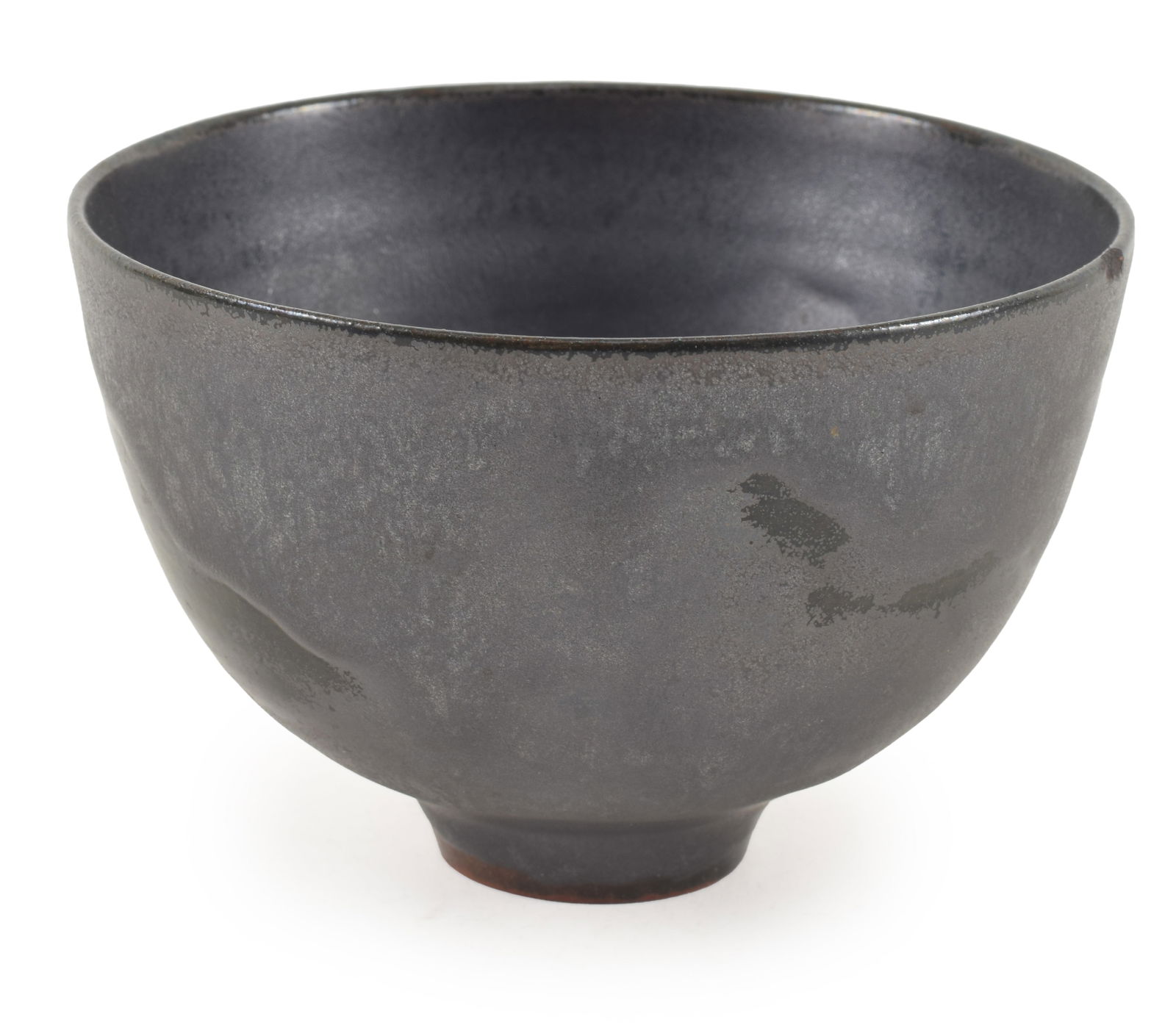 Gertrude & Otto Natzler. Small art pottery footed bowl with black partially textured glaze. Elements: Gertrude & Otto Natzler. Small art pottery footed bowl with black partially textured glaze. Elements of matte and gloss finishes with opalescent sheen. Signed on interior of foot. Small flake chip on