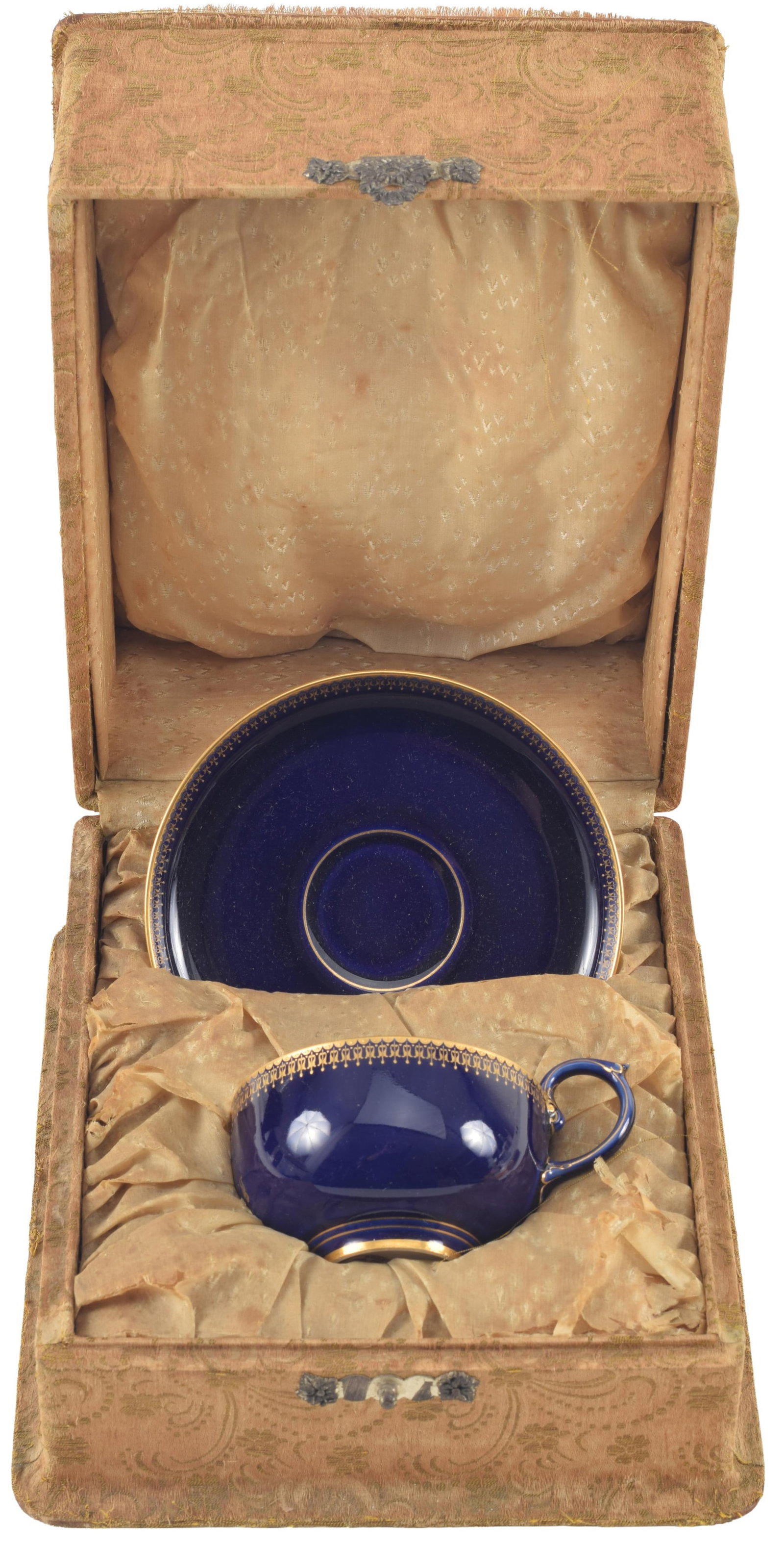 19th century Dore A Sevres armorial presentation porcelain cup and saucer. Gilt decoration on a: 19th century Dore A Sevres armorial presentation porcelain cup and saucer. Gilt decoration on a cobalt blue ground. Armorial crest on cup. Housed in original silk brocade presentation case. Saucer: 5.