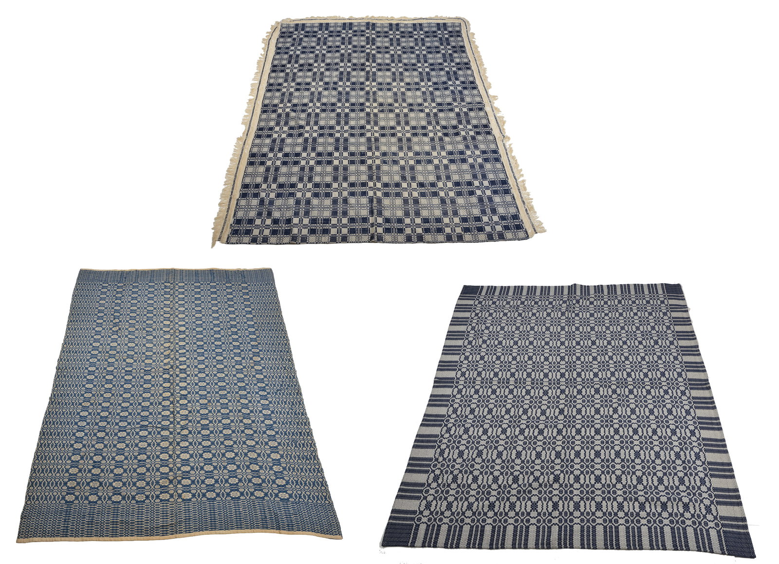 3 Jacquard coverlets including: Denim, Blue, White - Geometric, overshot, seamed. Unsigned. 79 x 108: 3 Jacquard coverlets including: Denim, Blue, White - Geometric, overshot, seamed. Unsigned. 79 x 108; Navy/Blue, White - Geometric, overshot. Unsigned. 84 x 96 and Red, Navy, Green, Cream - Geometric.