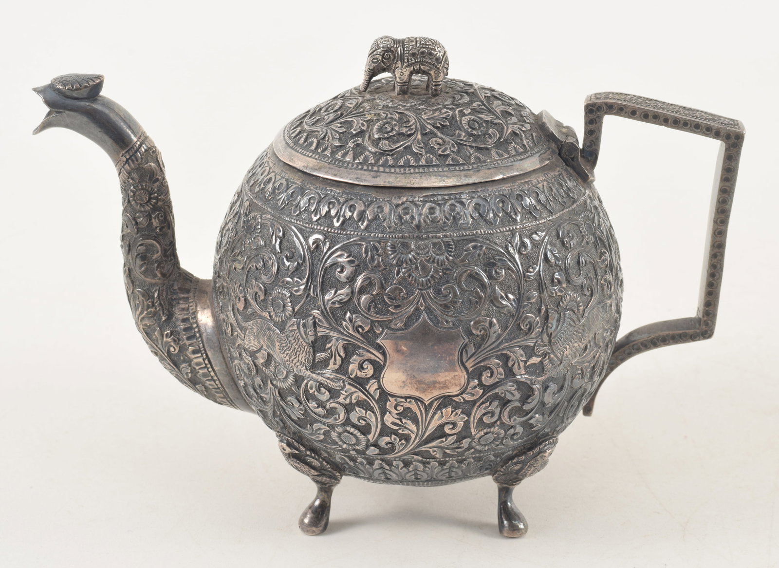 Anglo Indian silver teapot with elephant finial and allover floral decorations with dogs. Height 5 (1 of 7)
