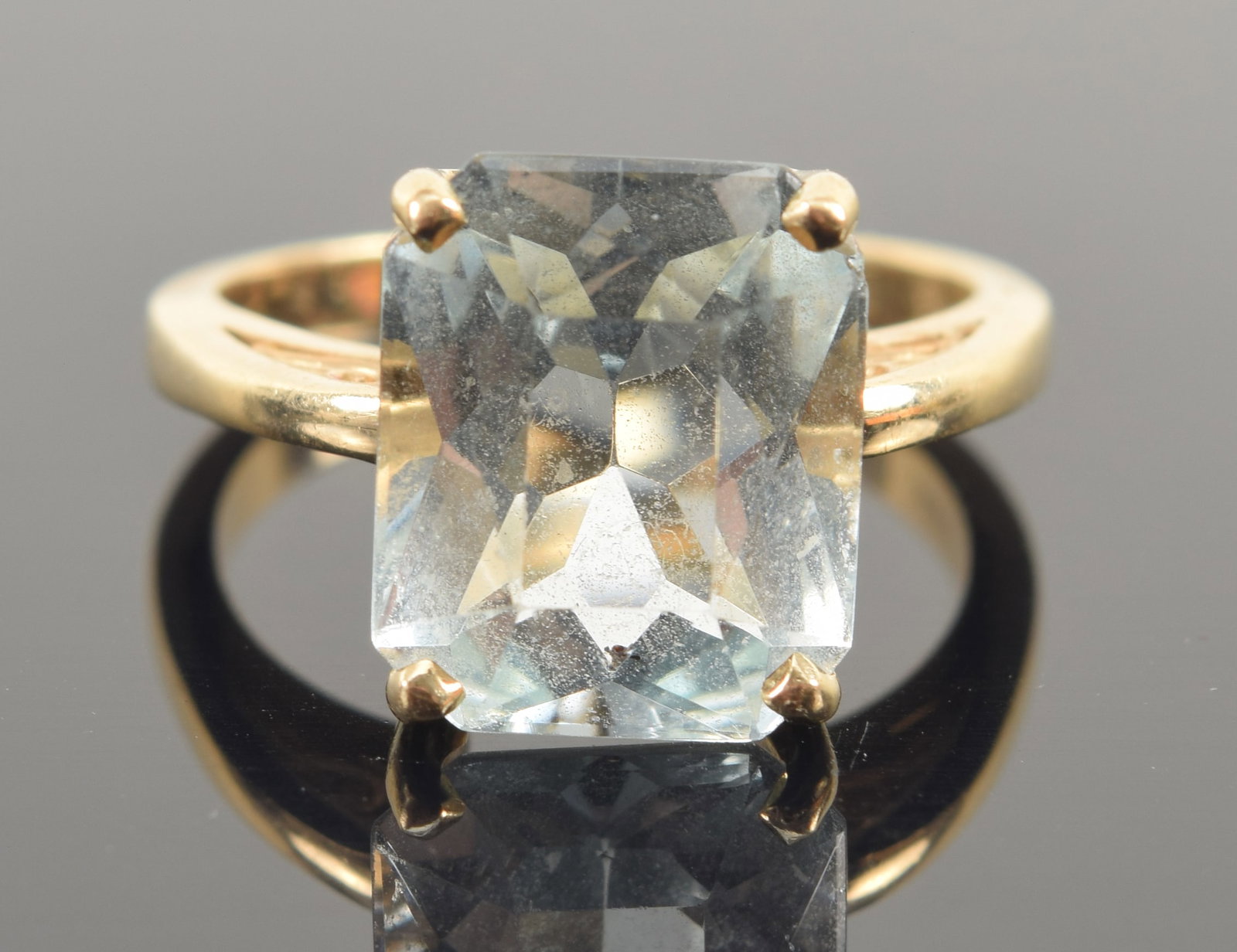 14K gold aquamarine ring. Faceted rectangular cut-corner aquamarine measures approx. 11.9 x 9.8mm.: 14K gold aquamarine ring. Faceted rectangular cut-corner aquamarine measures approx. 11.9 x 9.8mm. Ring marked 14K. Ring size 6.5. 4.8 grams.