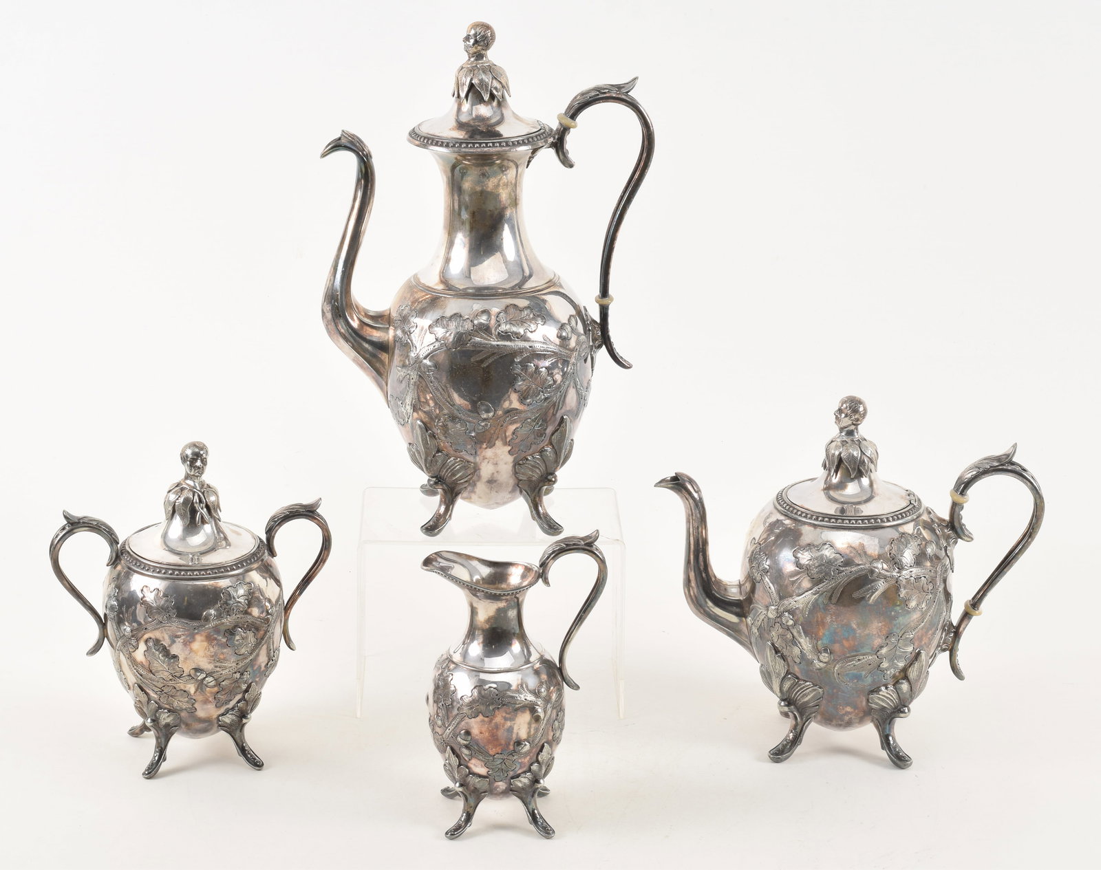 19th century American silver 4 piece tea set with finials depicting American statesman Daniel: 19th century American silver 4 piece tea set with finials depicting American statesman Daniel Webster. Chased and embossed oak leaf and acorn decoration. Finials with the bust of Daniel Webster and fo