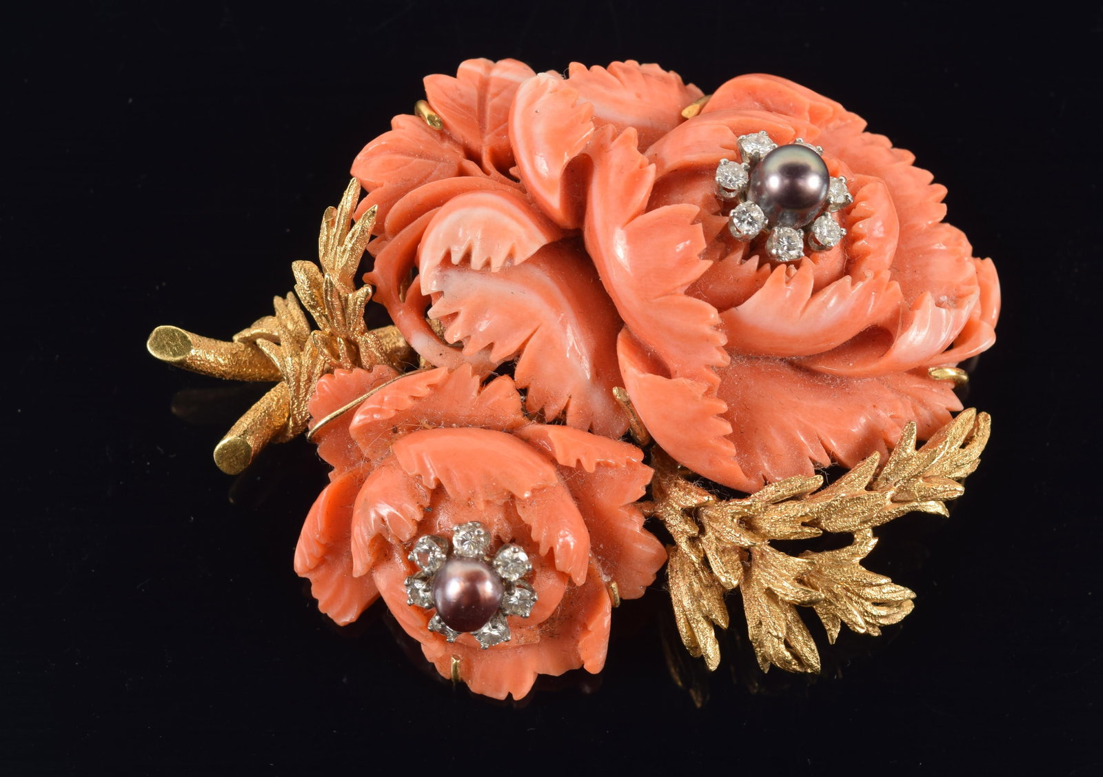David Webb 18K gold and platinum carved coral and diamond floral form brooch. Carved coral flowers,: David Webb 18K gold and platinum carved coral and diamond floral form brooch. Carved coral flowers, each set with single black pearl in center surrounded by halo of 7 round cut diamonds (each about 2.