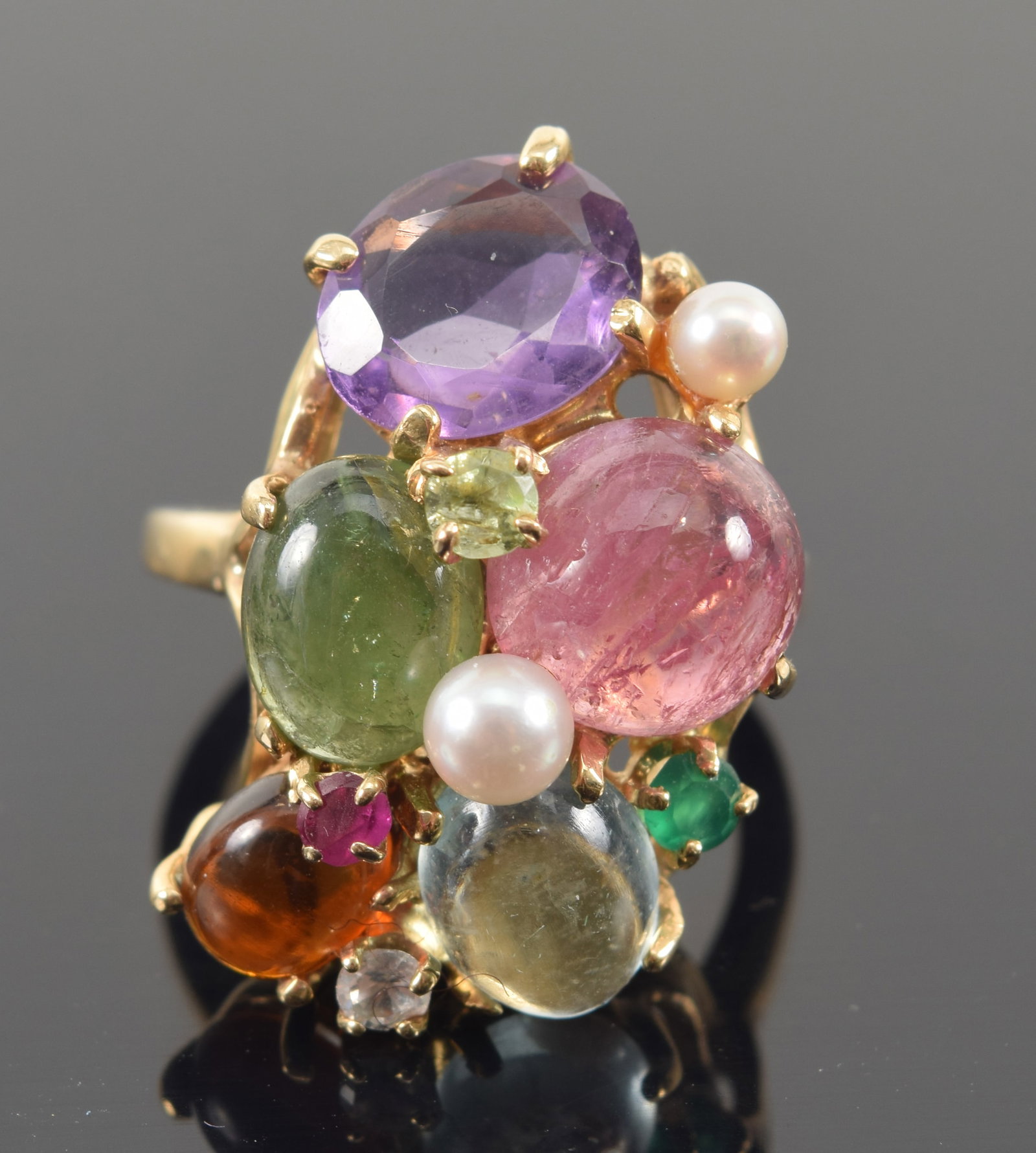 14K gold multi-gemstone and pearl set cluster ring. Naturalistic openwork setting. Amethyst,: 14K gold multi-gemstone and pearl set cluster ring. Naturalistic openwork setting. Amethyst, emerald, rose quartz, peridot, etc. Marked 14K. Ring size 6. 9.7 grams.