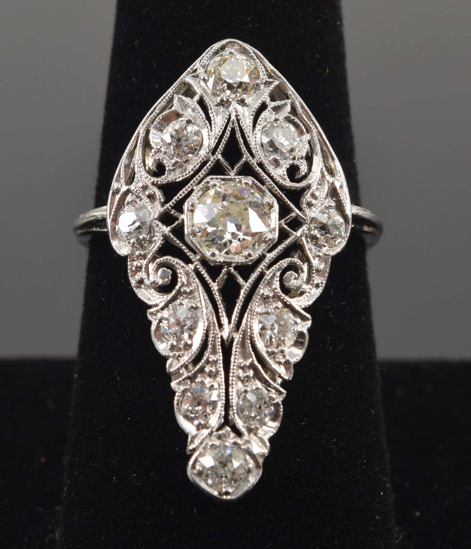 Edwardian platinum 1.20CTW diamond ring. Reticulated foliate scrollwork setting. Central diamond: Edwardian platinum 1.20CTW diamond ring. Reticulated foliate scrollwork setting. Central diamond approx. 5.3mm diameter and of slightly yellow color. Ring size 8.25. 6.2 grams.