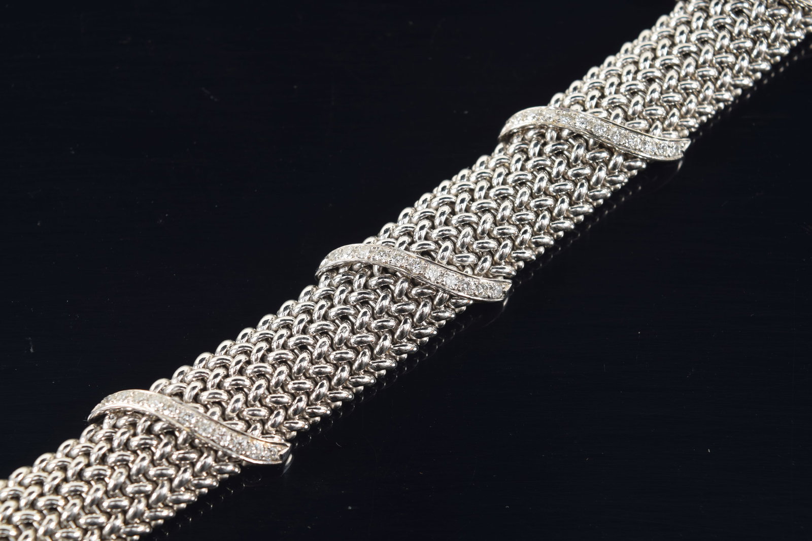 14K white and yellow gold mesh bracelet with diamonds. 5 spiral bands of round cut diamonds, plus an: 14K white and yellow gold mesh bracelet with diamonds. 5 spiral bands of round cut diamonds, plus an additional channel of diamonds on the clasp. Stones each about 1.5mm diameter. 63 diamonds in total