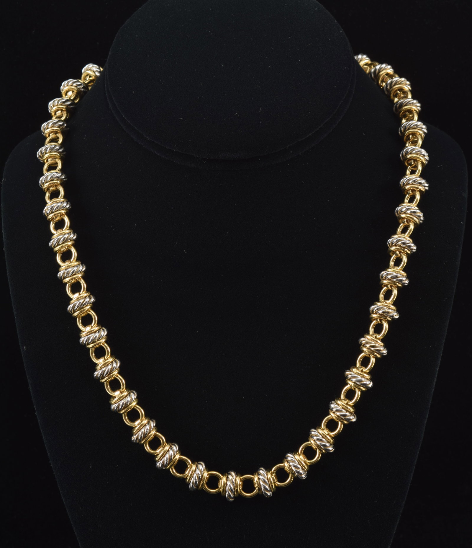 18K white and yellow gold heavy ring link necklace. Pattern of polished yellow gold rings flanking: 18K white and yellow gold heavy ring link necklace. Pattern of polished yellow gold rings flanking larger braided white gold rings. Toggle clasp decorated with blue enamel accents and marked. 18in len