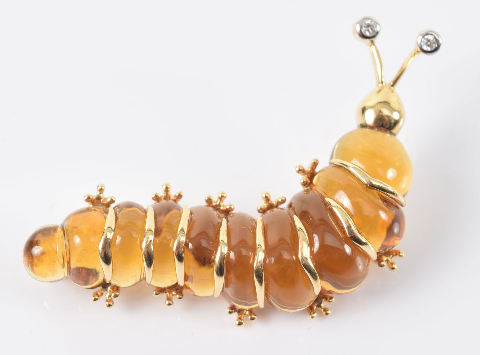 18K gold citrine and diamond caterpillar pin. Marked 750. 1.75in length. 11.2 grams.: 18K gold citrine and diamond caterpillar pin. Marked 750. 1.75in length. 11.2 grams.