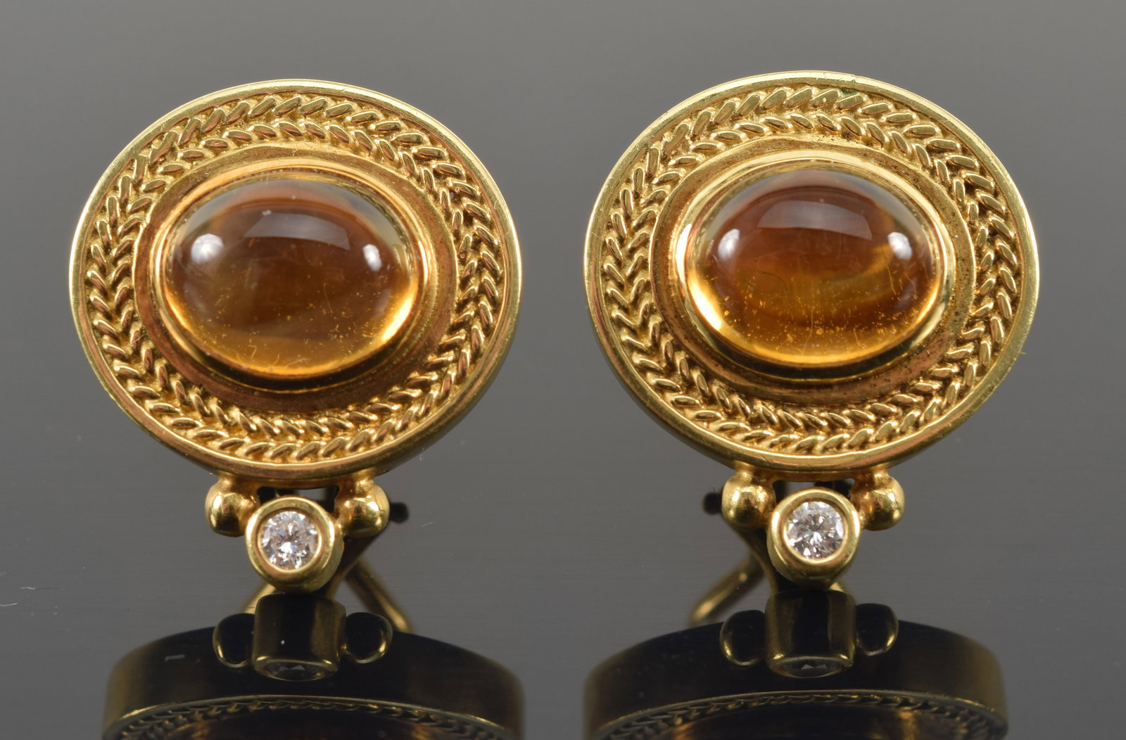 Seidengang 18K gold citrine and diamond mounted earrings. Oval citrine cabochons measuring about 10: Seidengang 18K gold citrine and diamond mounted earrings. Oval citrine cabochons measuring about 10 x 8mm. Small round brilliant cut diamonds about 2.4mm diameter. Classical wreath and beadwork design