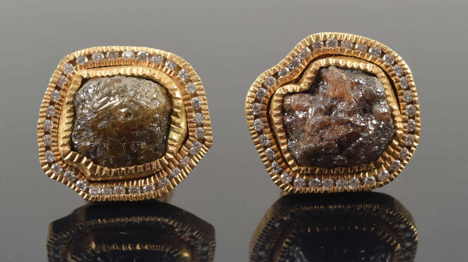 Todd Reed 18K gold raw diamond specimen mounted earrings. Each uniquely contoured with a row of: Todd Reed 18K gold raw diamond specimen mounted earrings. Each uniquely contoured with a row of small white color round cut diamonds, approx. 0.25ctw. Signed on reverse. Each about 5/8in wide. 11.8 gr