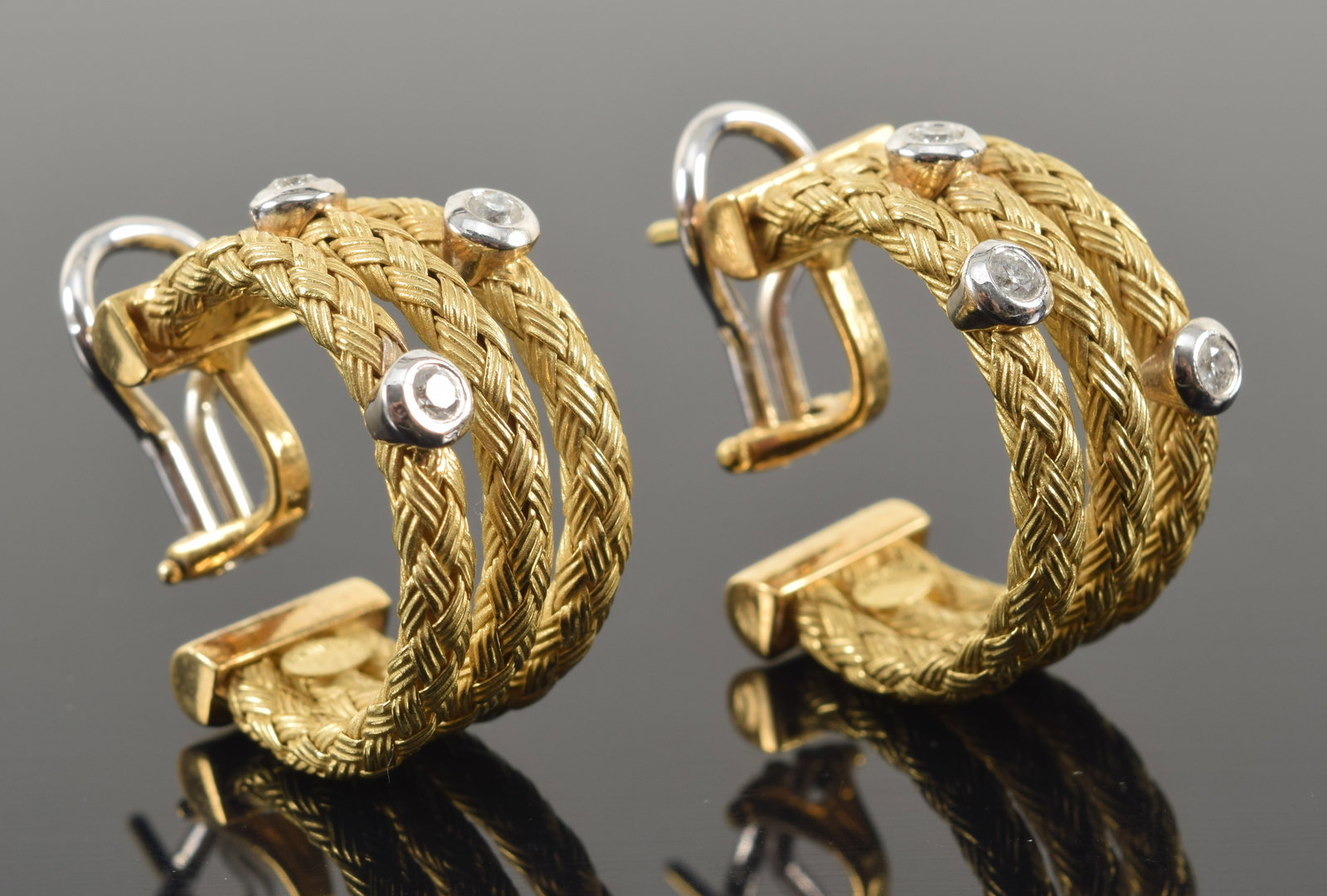 18K gold triple band weave pattern earrings with diamonds. Diamonds each about 2.2mm diameter and: 18K gold triple band weave pattern earrings with diamonds. Diamonds each about 2.2mm diameter and set in white gold. Marked on interior of earrings 18K and Italy. 18.1 grams. 7/8in length.