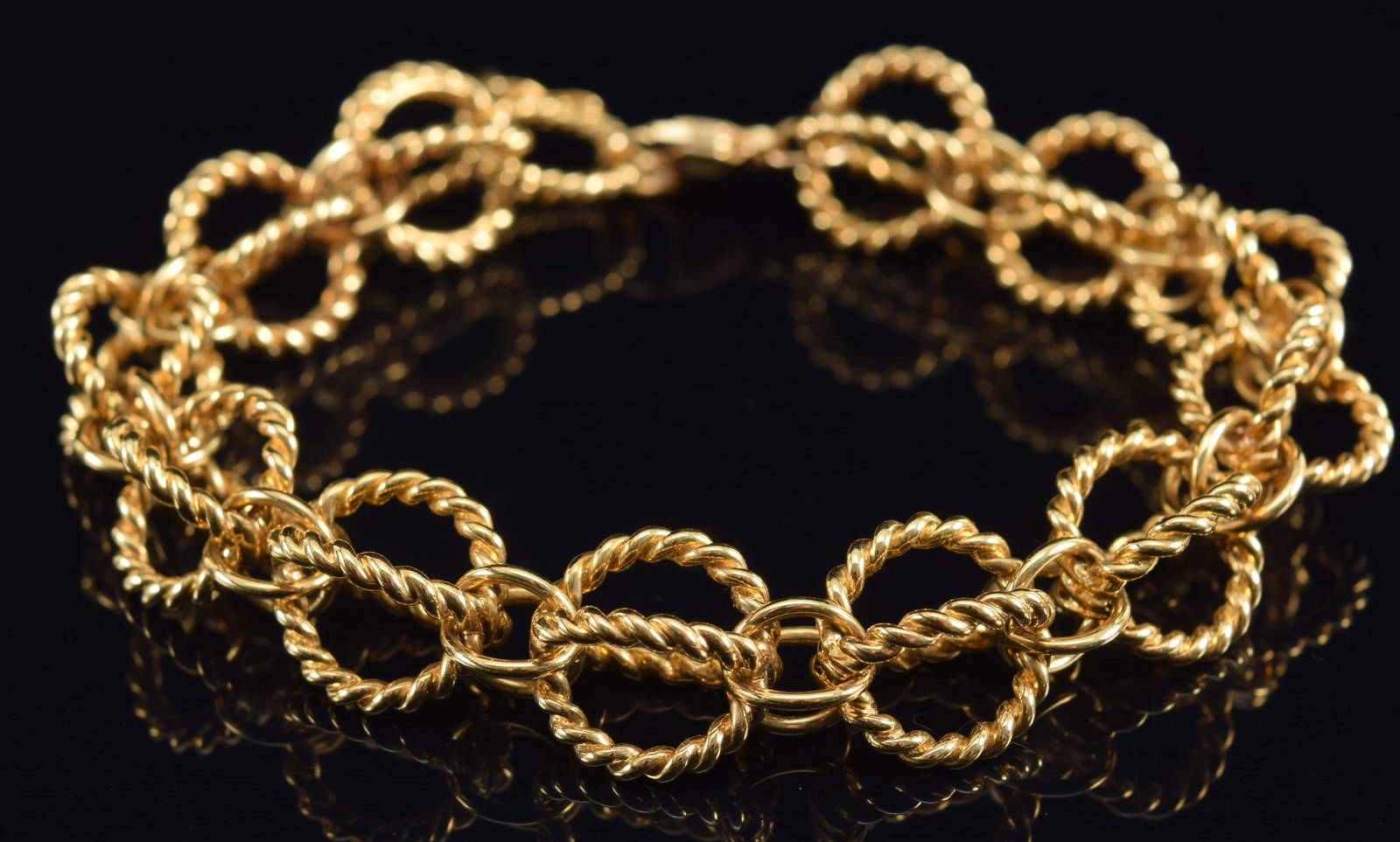 18K gold braided open-twist link bracelet. 8in length. Marked 750 on clasp. 40.4 grams. (1 of 4)