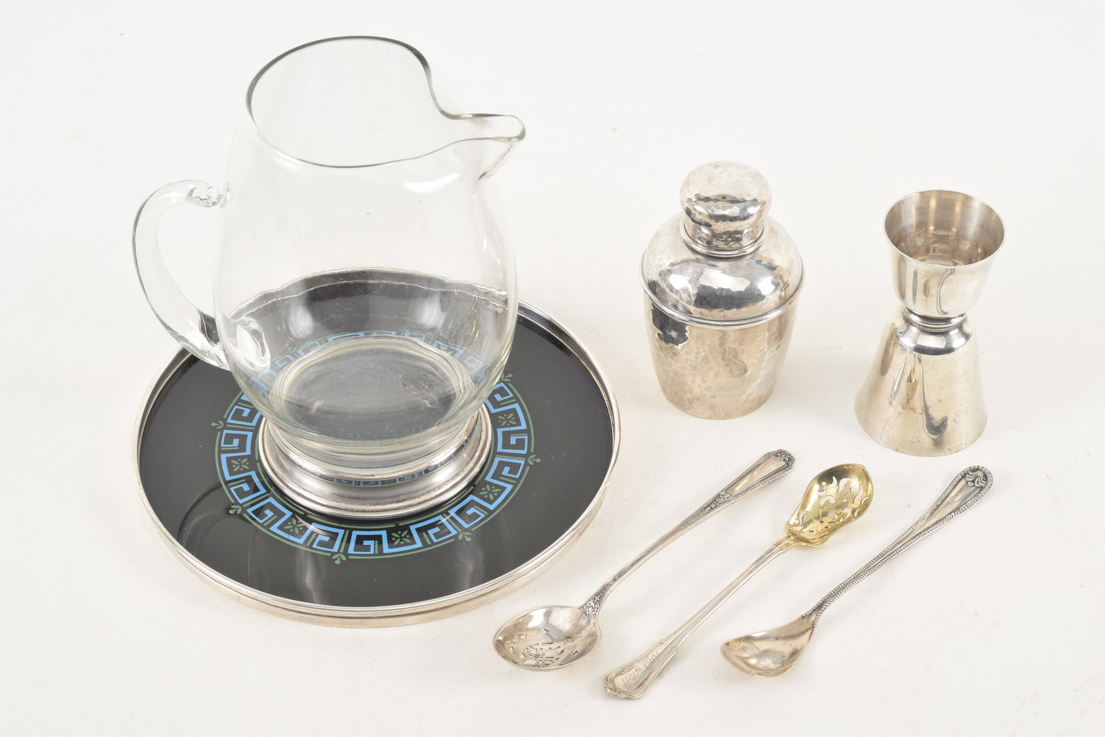 Collection of 7 sterling silver items, including a Gorham silver rimed tray with glass Greek key: Collection of 7 sterling silver items, including a Gorham silver rimed tray with glass Greek key decorated base, a crystal pitcher with silver foot, a Kirk & Sons drinks measure, small drinks shaker a