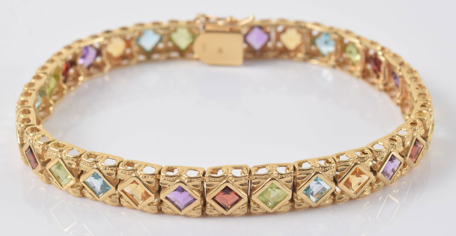 14K gold multi-colored gemstone mounted bracelet. Reticulated square settings with garnets, (1 of 5)