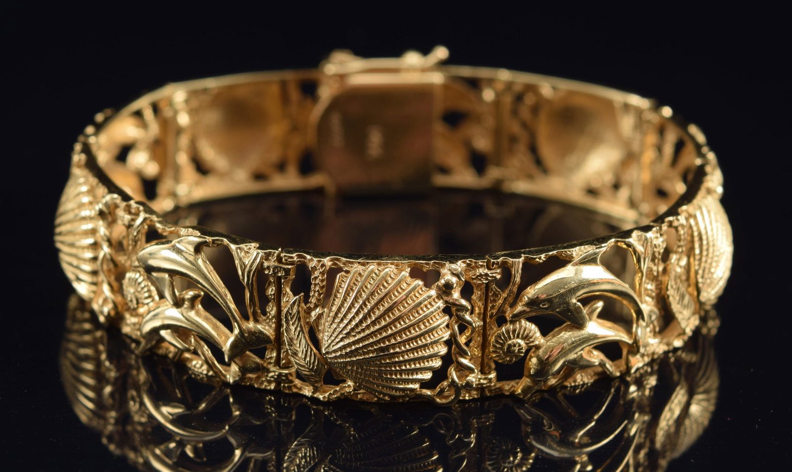 14K gold nautical motif bracelet. Alternating ocean scenes with dolphins and ammonites, and (1 of 6)