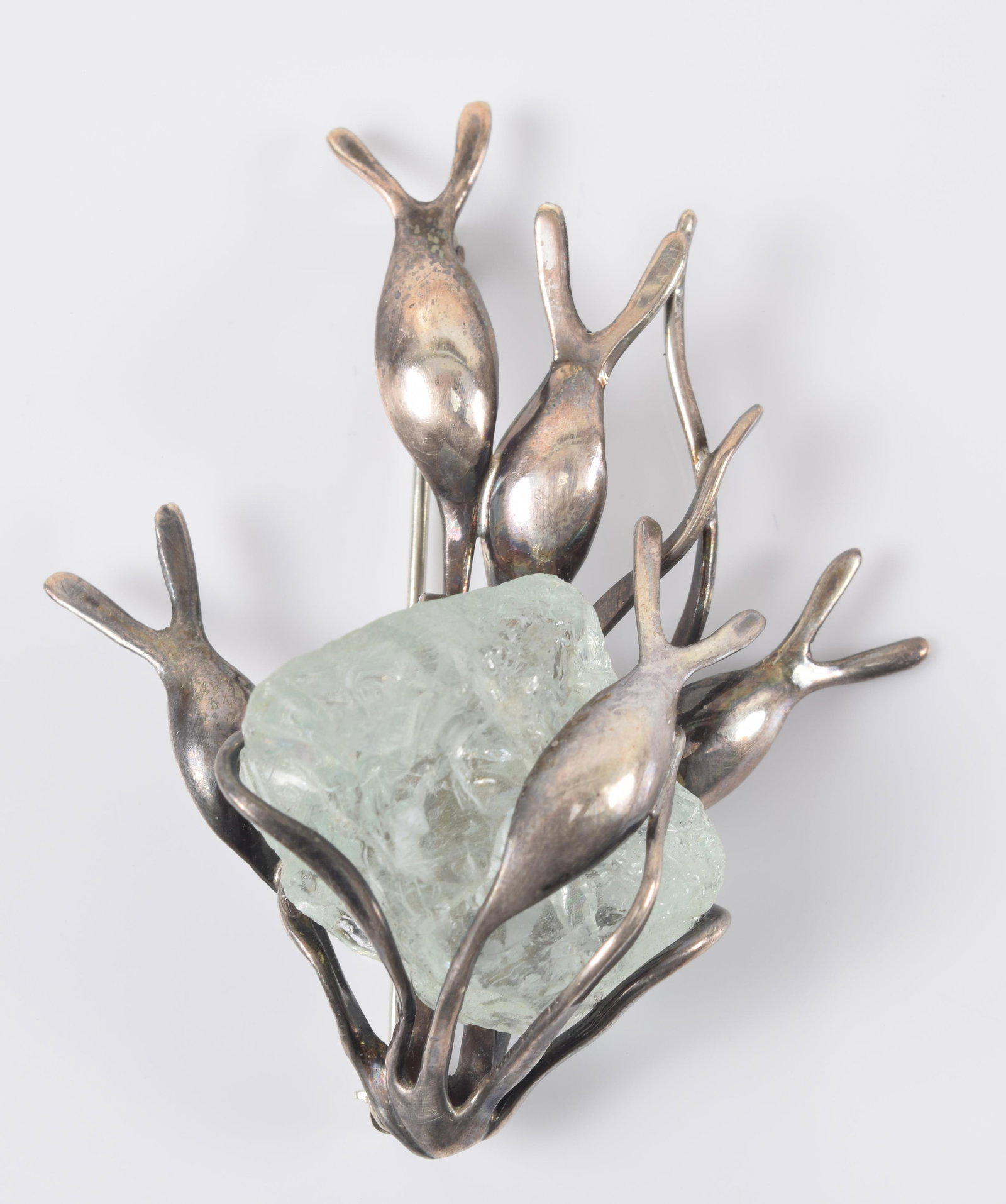Clifford Russell. Maine. Sterling silver seaweed form pin with natural aquamarine specimen. Marked: Clifford Russell. Maine. Sterling silver seaweed form pin with natural aquamarine specimen. Marked on reverse. 2.25in length.