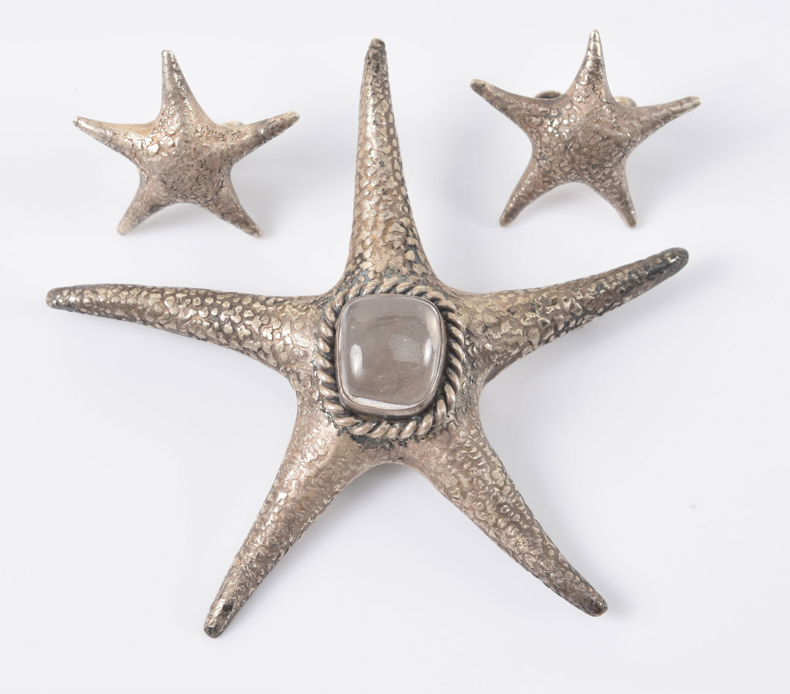 Clifford Russell. Maine. Sterling silver starfish pin and earring set. pin set with light grey smoky: Clifford Russell. Maine. Sterling silver starfish pin and earring set. pin set with light grey smoky colored stone. Signed on reverse. Pin 3 1/8in wide. 0.6 ozt.