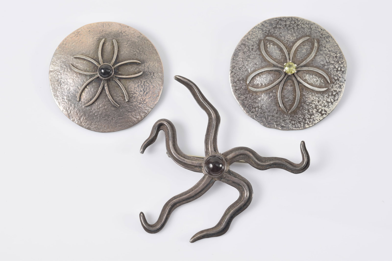 Clifford Russell. Maine. Sterling silver ocean themed jewelry. 1) 2 gem set sand dollar pins. Each (1 of 6)