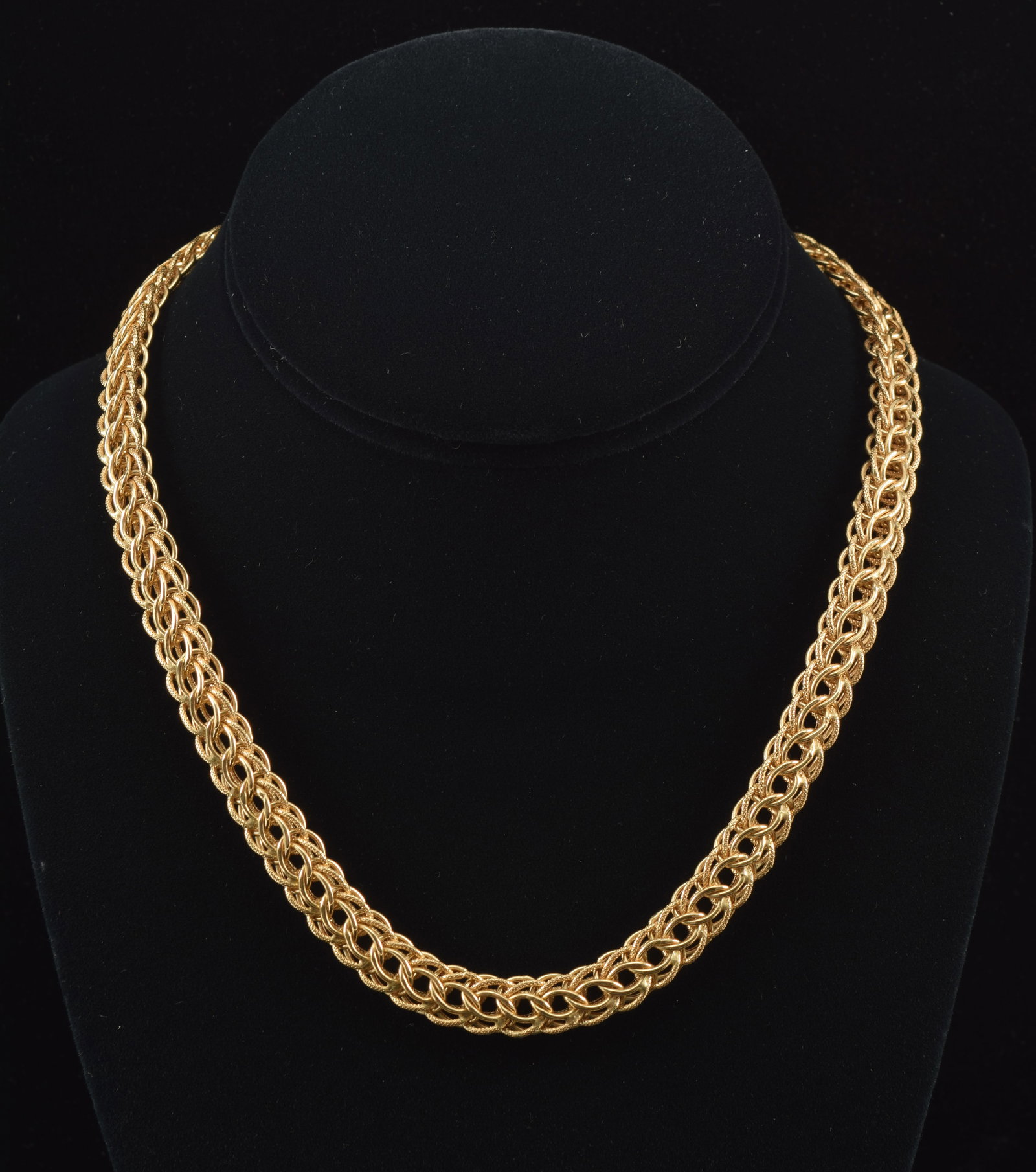 18K gold braided open link necklace. Textured and polished finishes. Clasp marked 750, Italy, and: 18K gold braided open link necklace. Textured and polished finishes. Clasp marked 750, Italy, and maker's mark. 16.5in length. 21.3 grams.