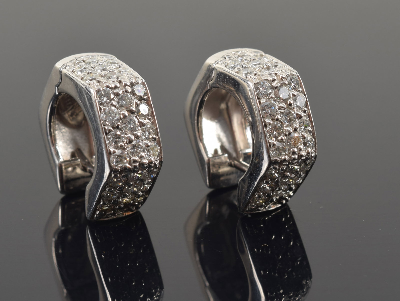 14K white gold diamond pave hexagonal form huggie earrings. Marked 14K on interior. 5/8in diameter. (1 of 3)