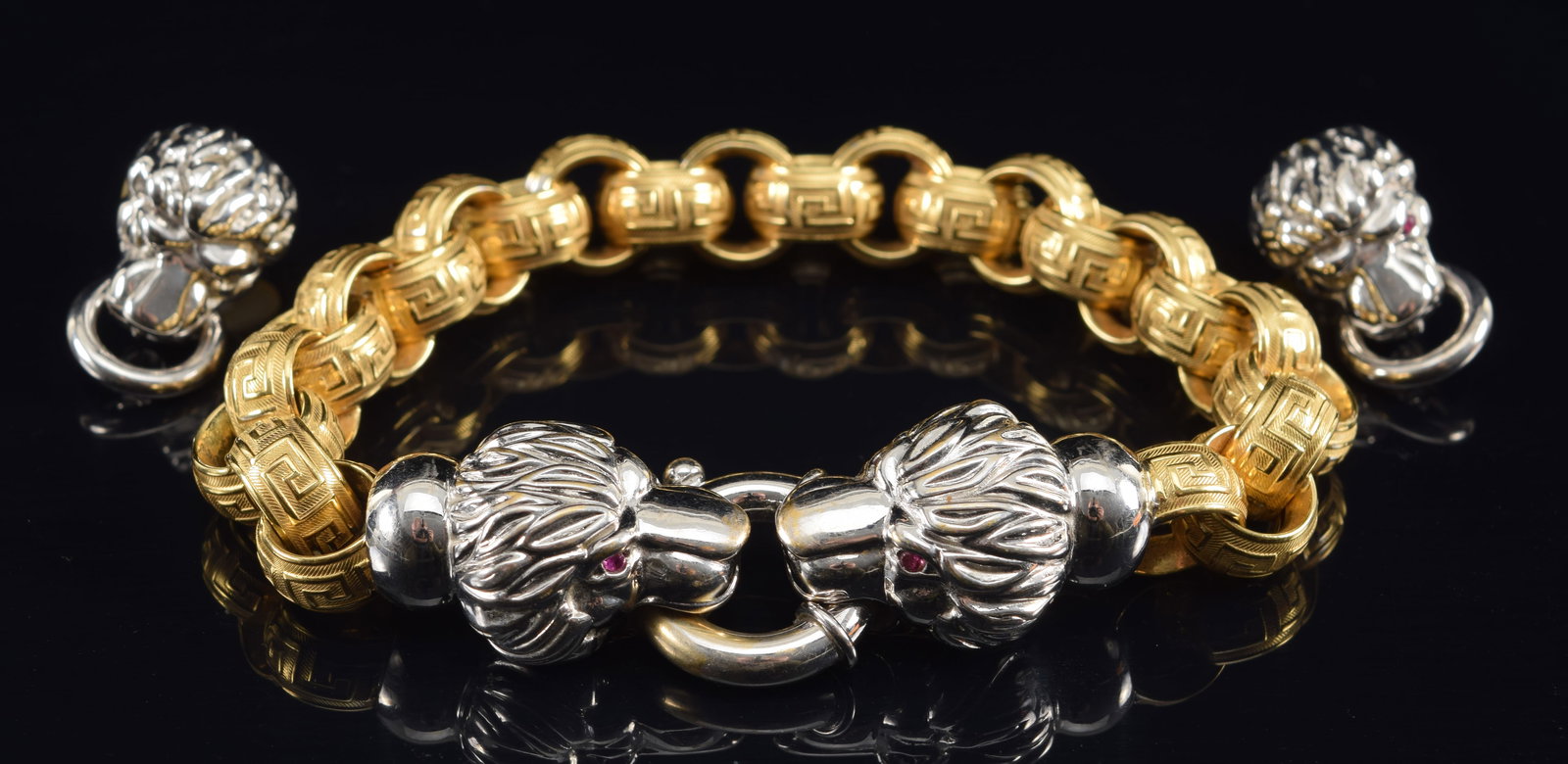 18K white and yellow gold Etruscan revival style bracelet and earrings set. Lion's head form: 18K white and yellow gold Etruscan revival style bracelet and earrings set. Lion's head form earrings and clasp with jump rings. Bracelet links ornately decorated with Greek key design in different fi
