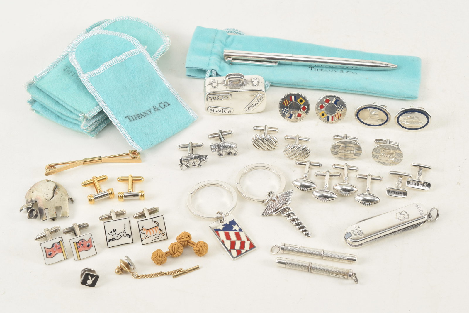 Large lot of Tiffany & Co. sterling silver cuff links and accessories. To include: 1) Enamel: Large lot of Tiffany & Co. sterling silver cuff links and accessories. To include: 1) Enamel decorated yacht signal flag cufflinks. 2) 2 pairs of football cufflinks. 3) Sterling silver pen. 4) 5 pairs