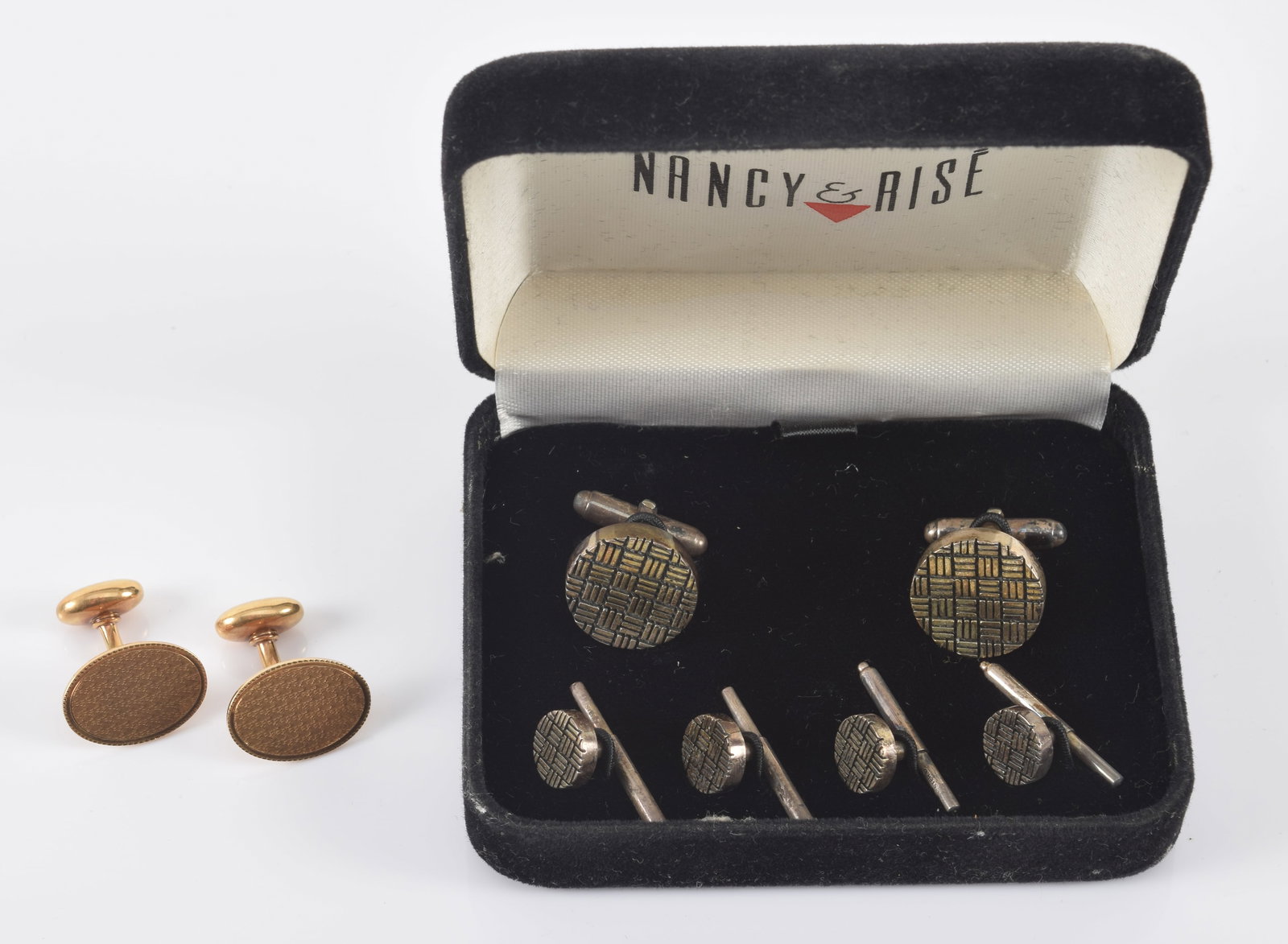 14K gold and sterling silver cufflinks. 1) Antique 14K gold cufflinks with oval faces and machined: 14K gold and sterling silver cufflinks. 1) Antique 14K gold cufflinks with oval faces and machined intricate pattern. 7.6 grams. 2) Sterling silver tuxedo set with cufflinks. Marked 925 NR.