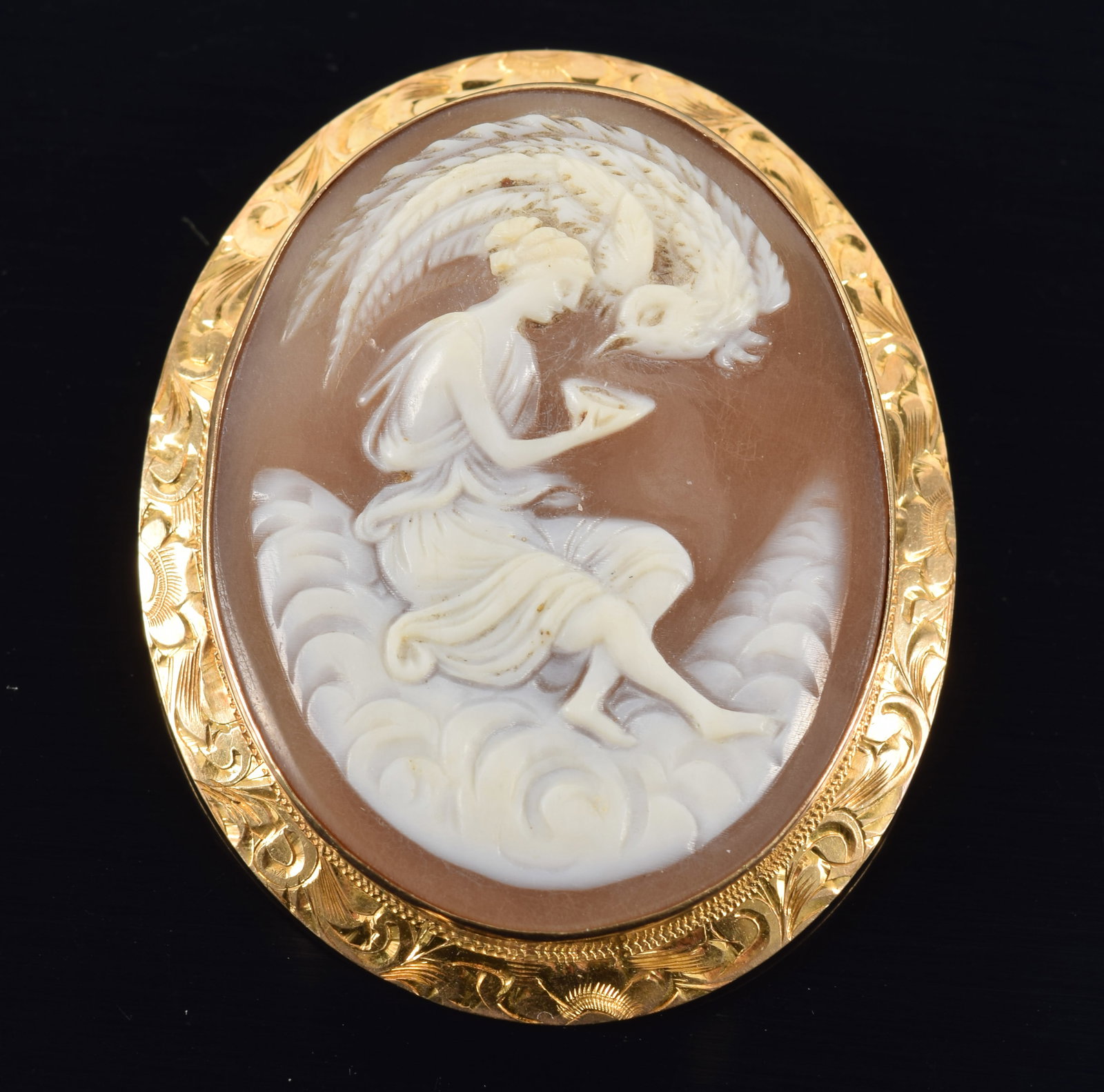 18K gold shell cameo pin/pendant. Classical allegory scene. Engraved scrolling decoration on frame.: 18K gold shell cameo pin/pendant. Classical allegory scene. Engraved scrolling decoration on frame. Marked 18K Italy on loop clasp. Hallmarked on backside of frame.1.75in length. 9.5 grams.