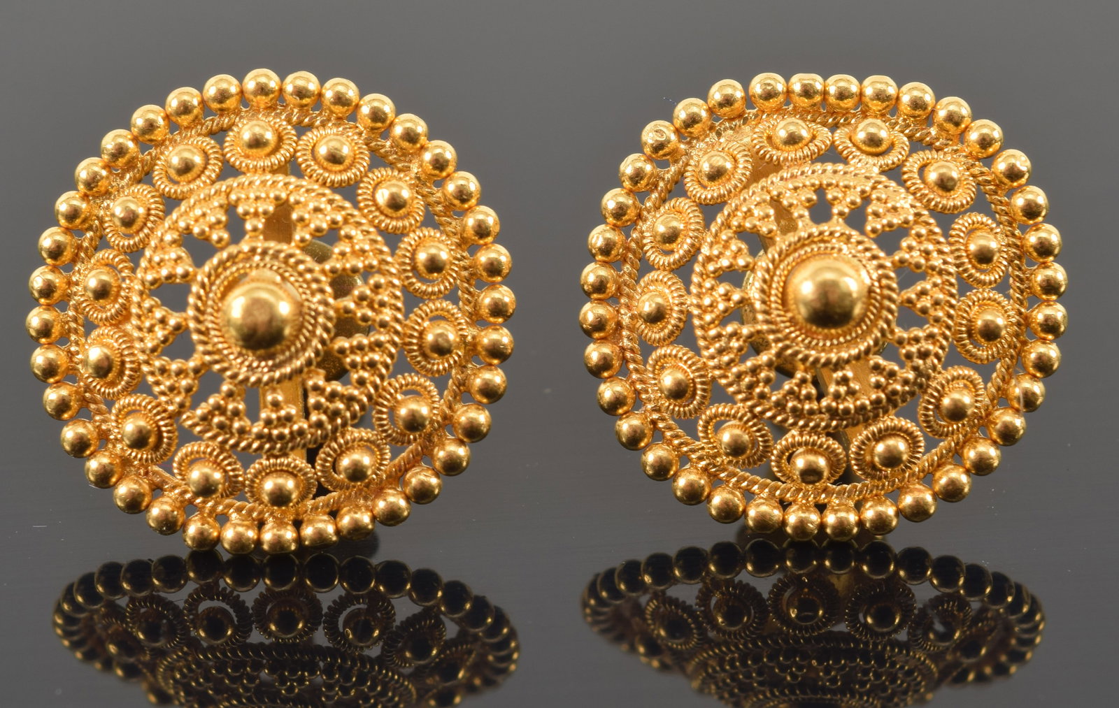Antique 22K gold Etruscan revival style openwork bead design earrings. Slightly domed form. Marked: Antique 22K gold Etruscan revival style openwork bead design earrings. Slightly domed form. Marked 22K on interior. One with slight bend on side. 5/8in diameter. 4.2 grams.